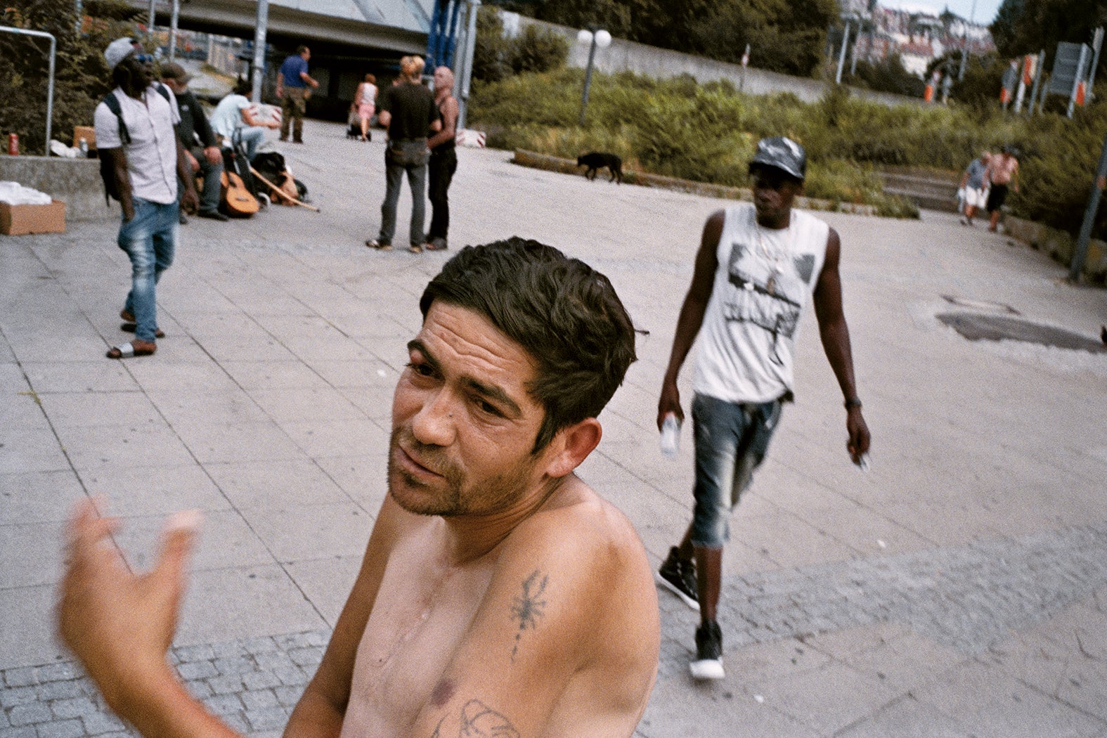 A man breaks away from a group of homeless people around the central station to chat with the photographer in Gorlitz