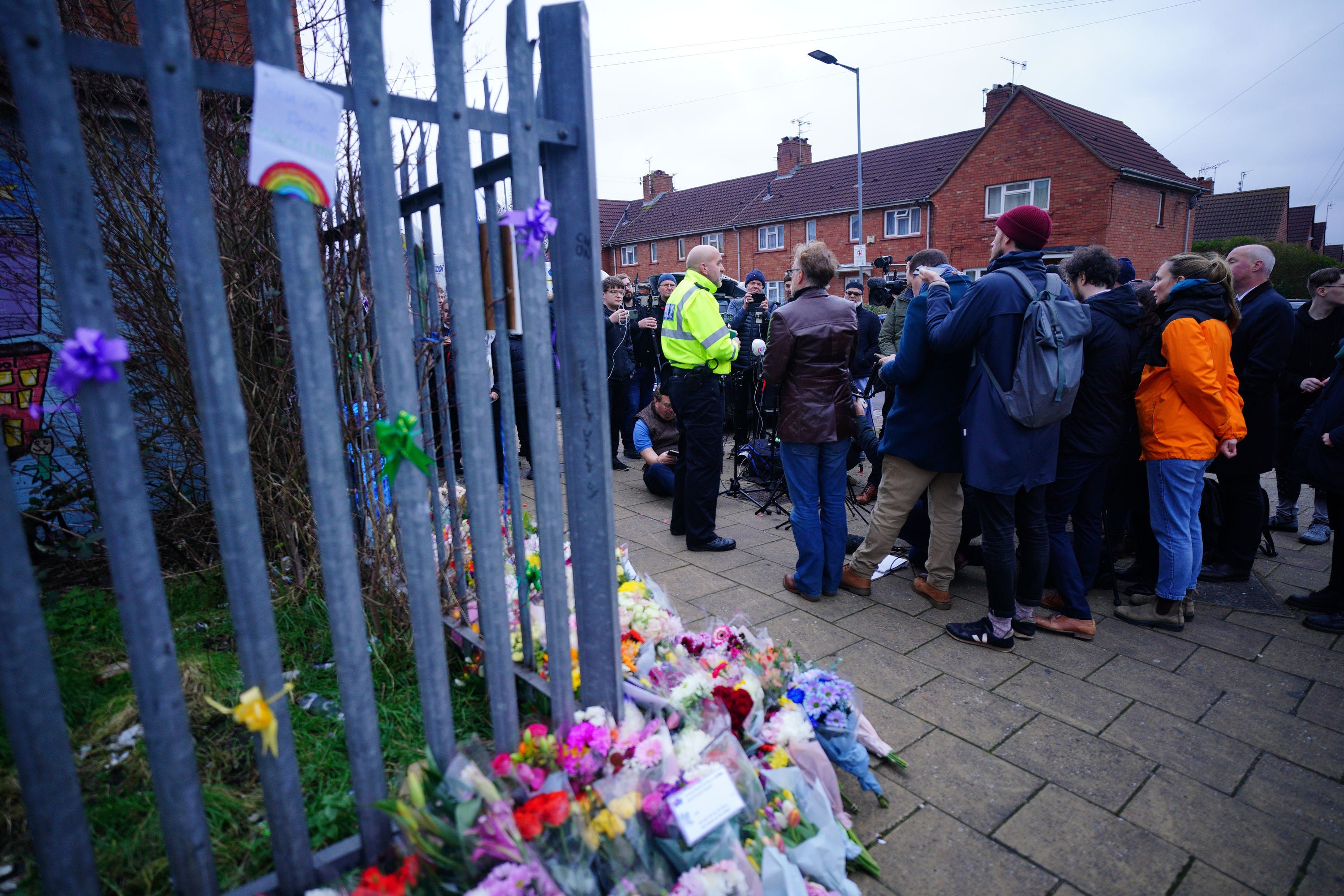 The community in mourning gather at the scene in Knowle West