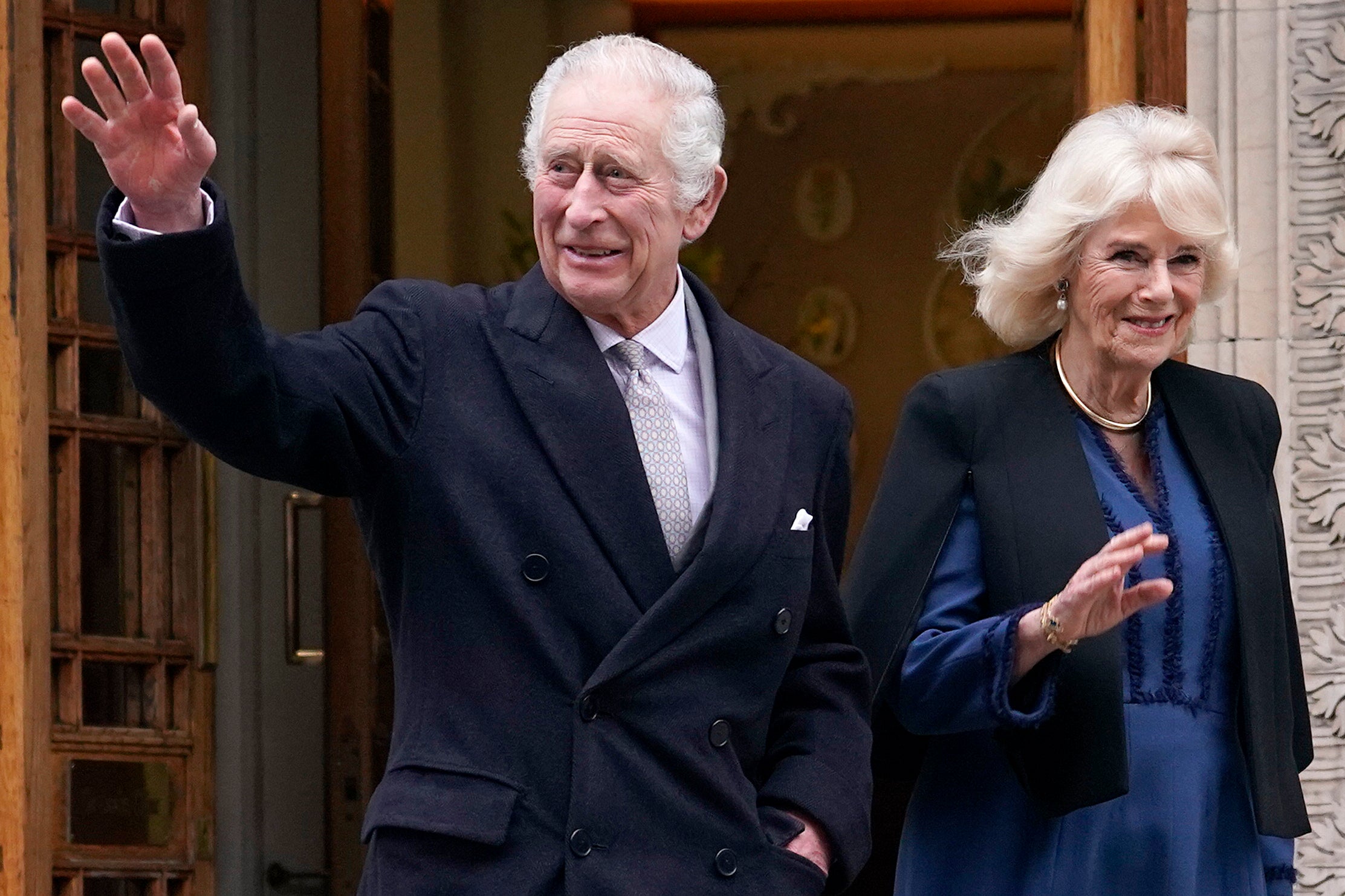 The King smiled and waved to members of the public as he left the private hospital with the Queen