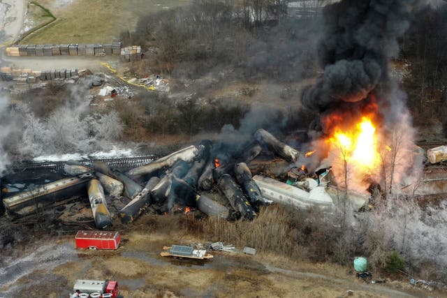 <p>Portions of a Norfolk Southern freight train that derailed the night before burn in East Palestine, Ohio, Feb. 4, 2023.</p>