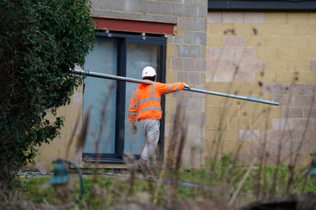 <p>Scaffolders work at the unauthorised spa pool block at the home of Captain Sir Tom Moore’s daughter Hannah Ingram-Moore</p>