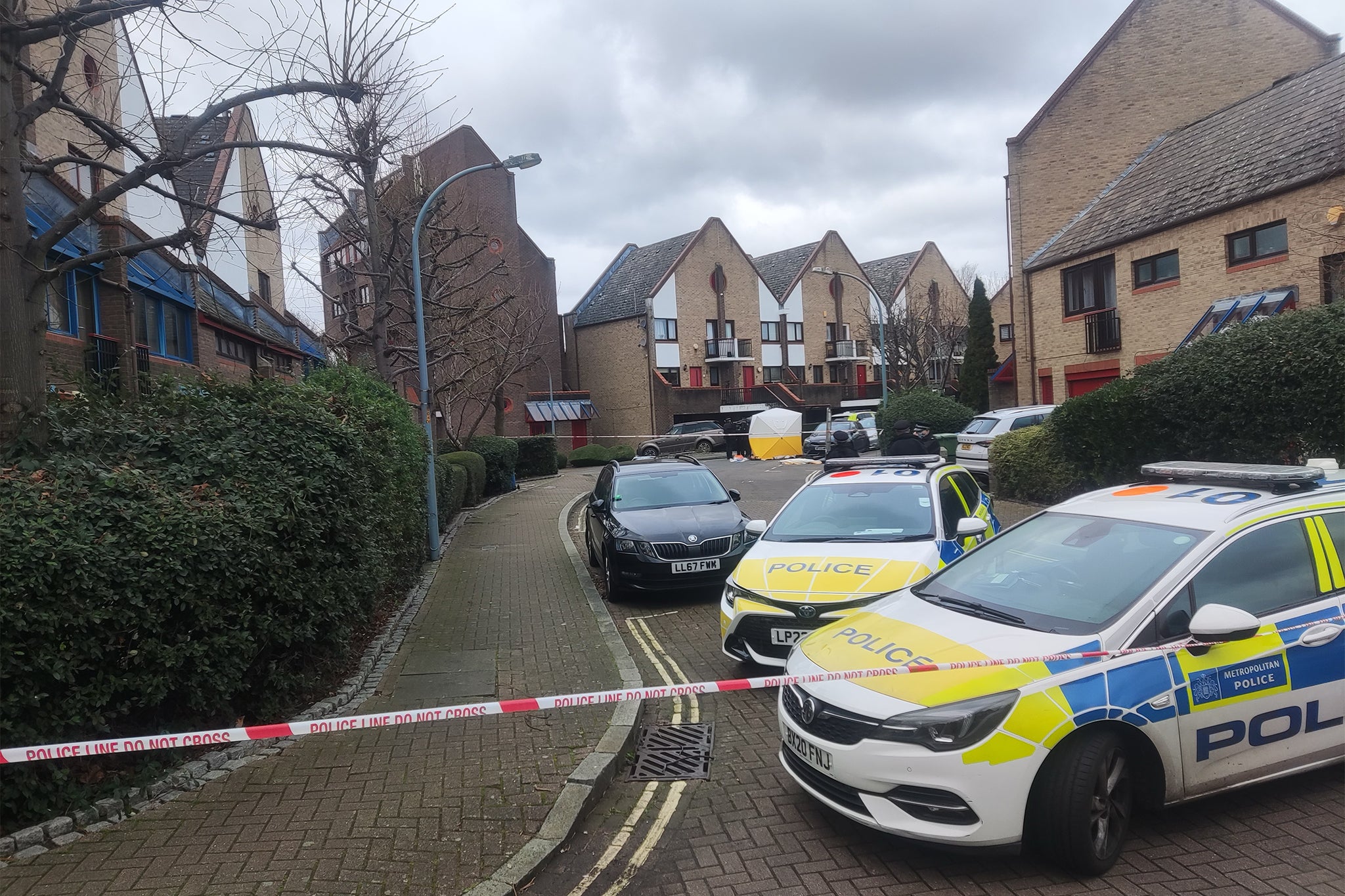 Police vehicles at the scene in Surrey Quays