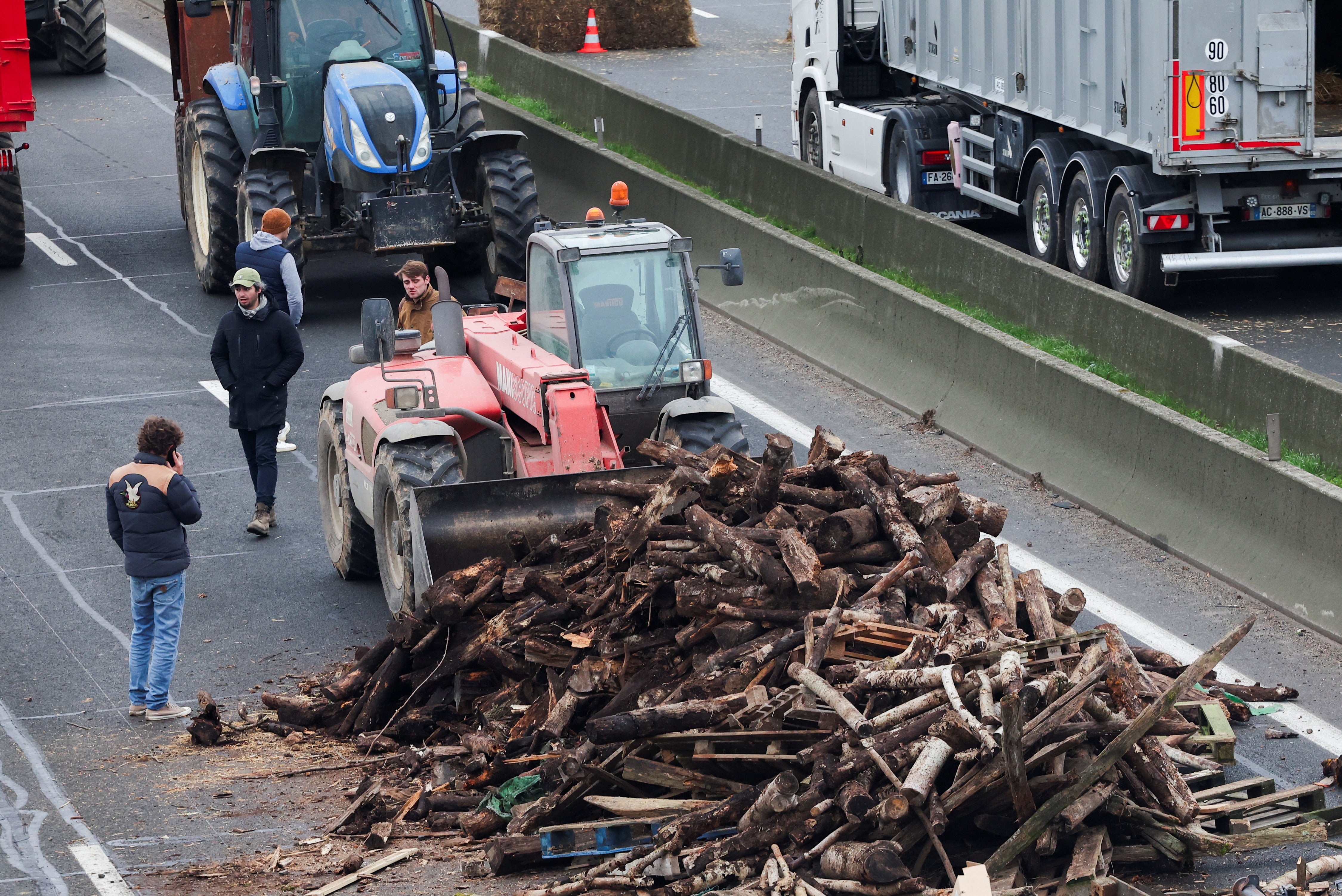 Wood is dumped on the road by farmers on the A4 highway