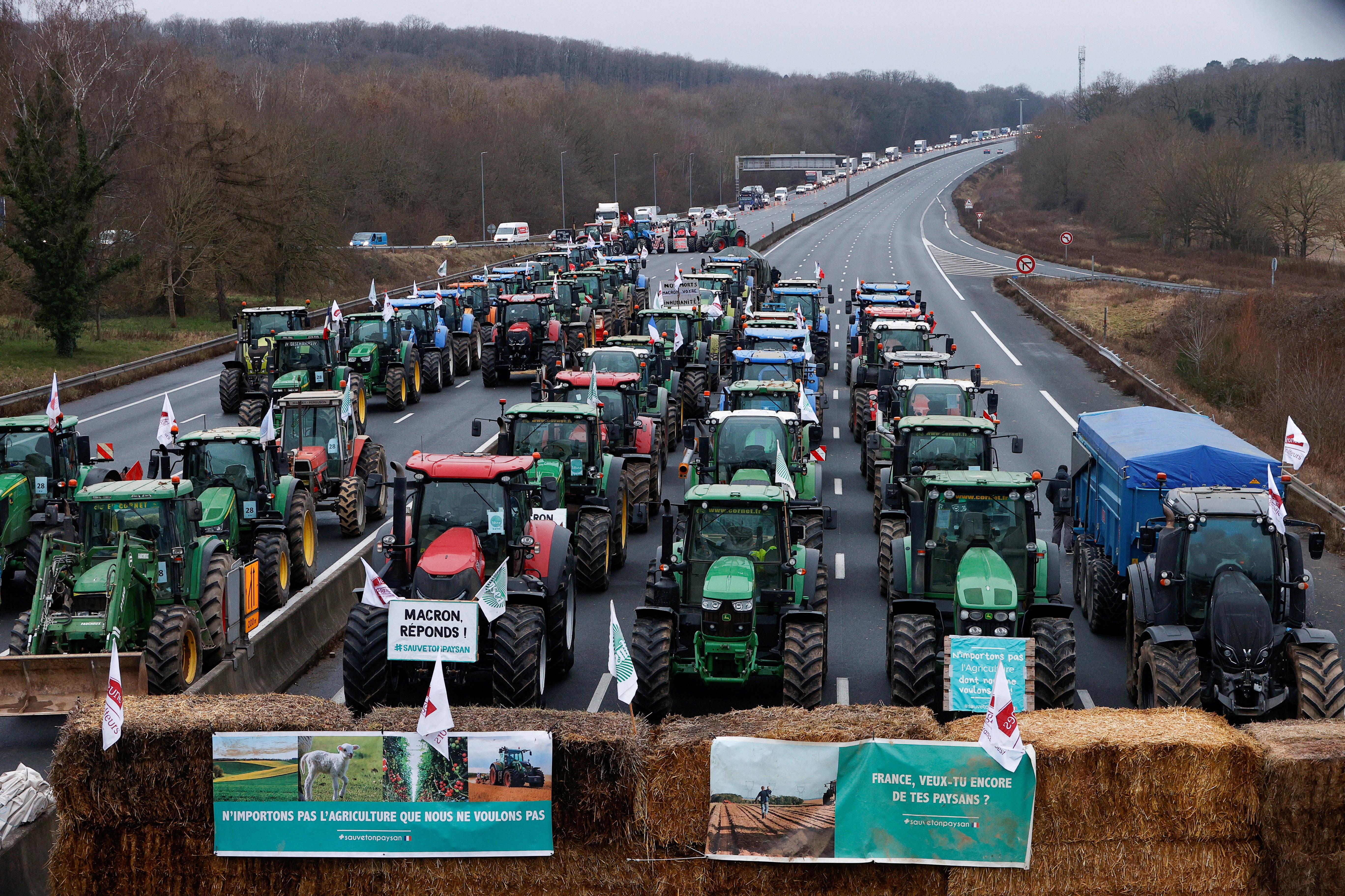 French farmers block a highway in Longvilliers, near Paris, before the EU summit on Thursday