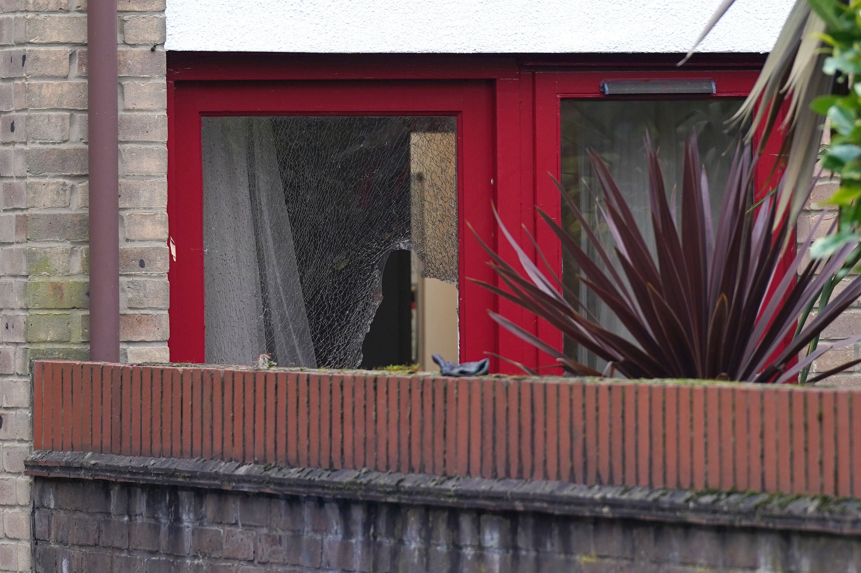 A smashed window at the back of the property where the man was shot dead