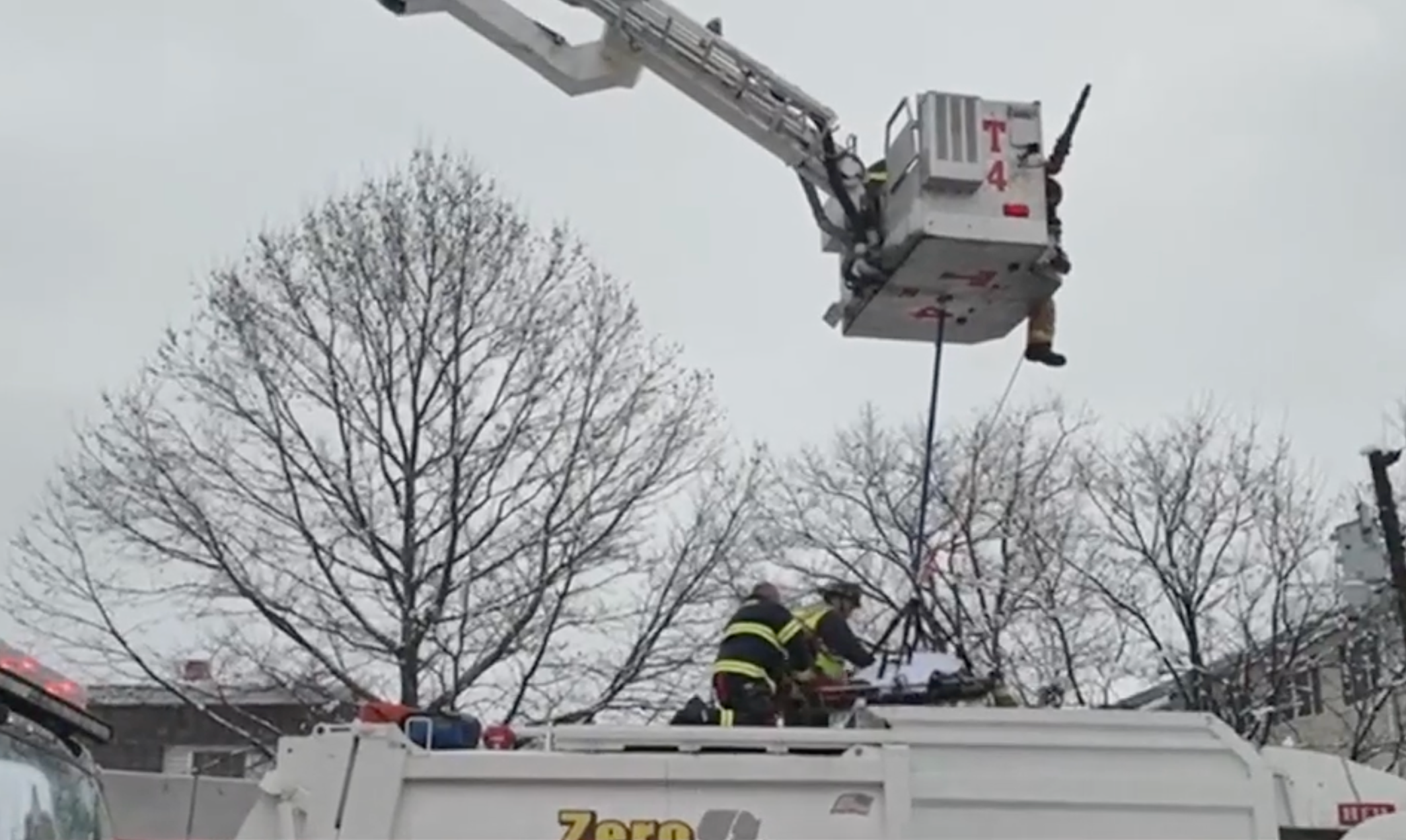 Firefighters later used a basket pulled by the fire truck crane to carefully hoist the woman to safety