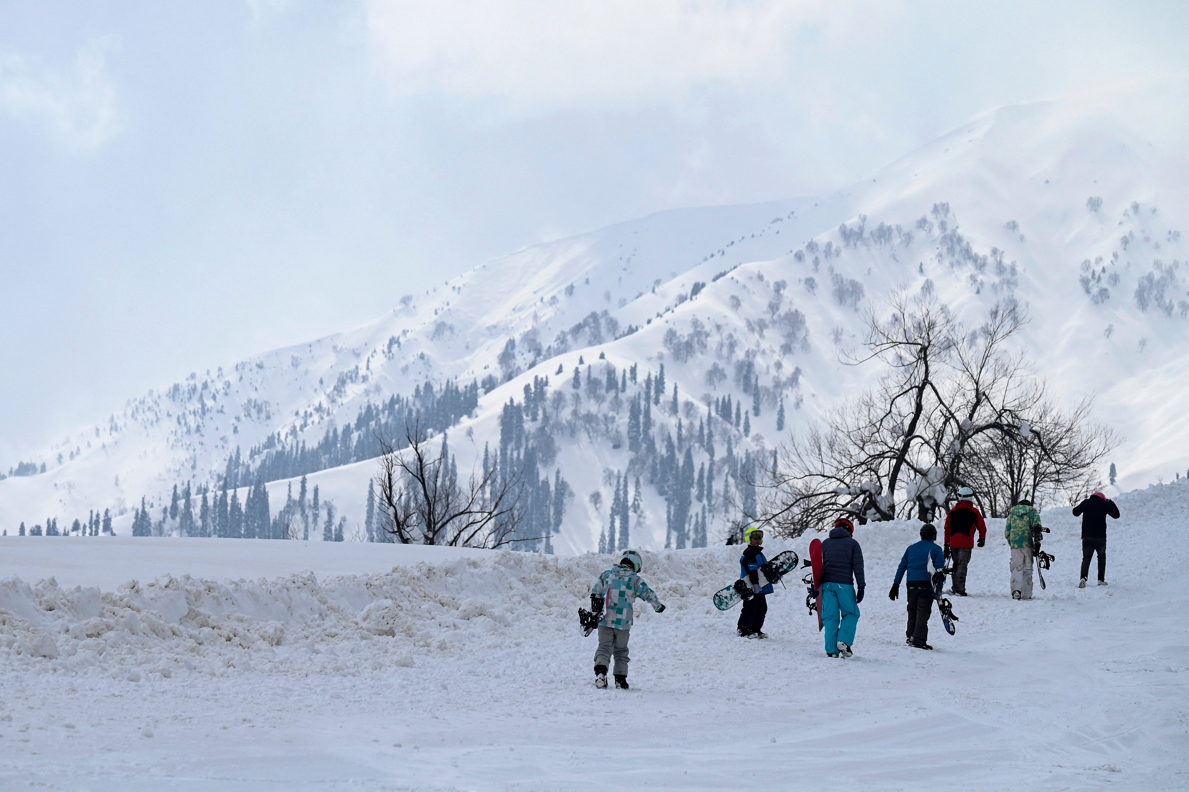 Participants walk during the opening ceremony of Khelo India Winter Games at a ski resort in Gulmarg north of Srinagar on February 10, 2023