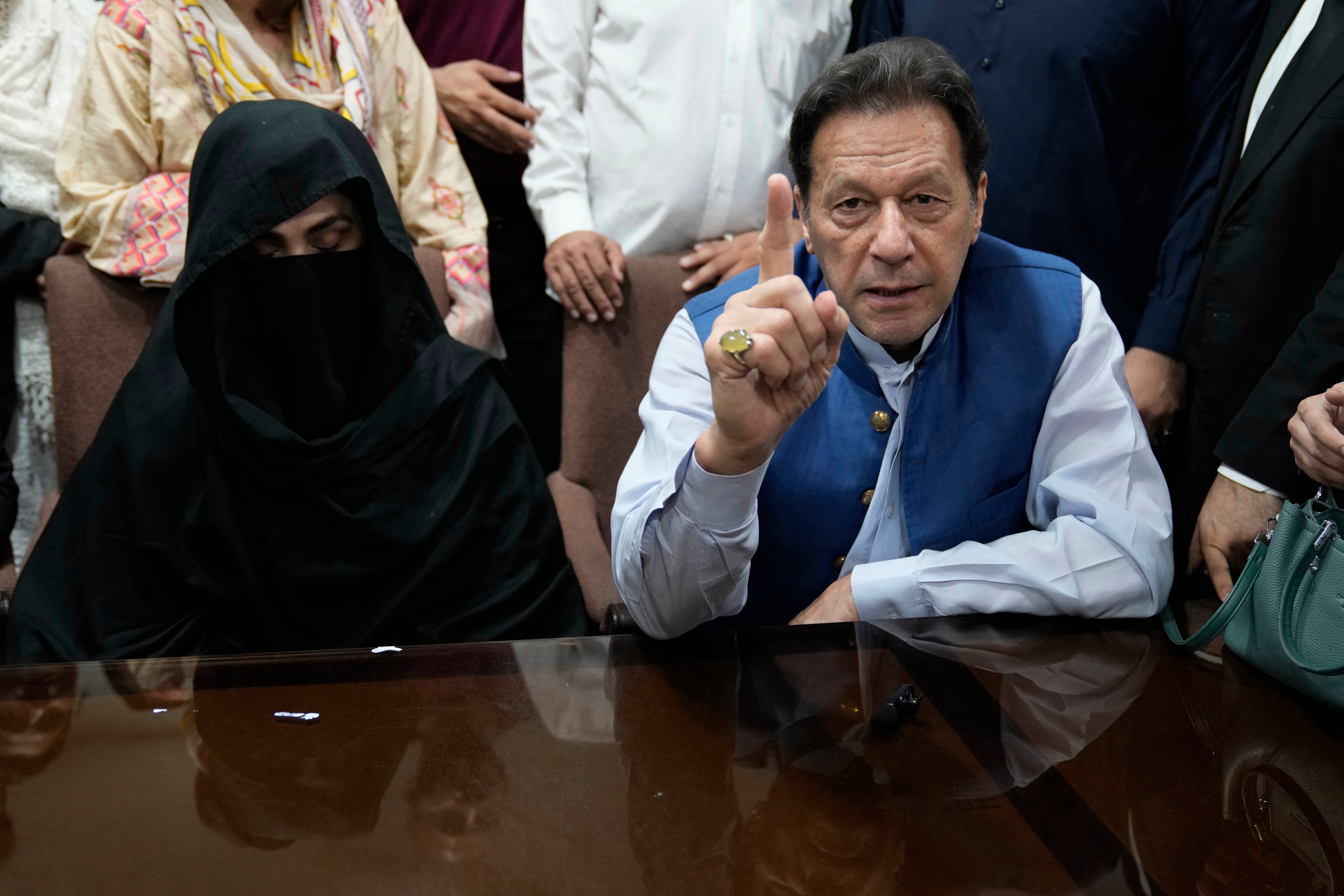Imran Khan talks to the media before signing documents to submit surety bond over his bails in different cases, at an office of Lahore High Court in Lahore, Pakistan, in 2023