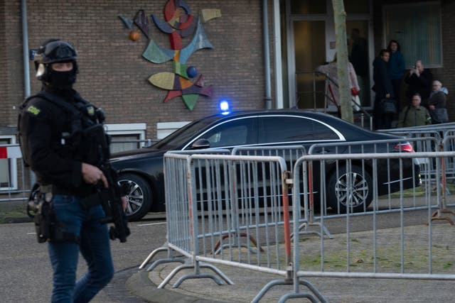 <p>Masked and armed Dutch police guard a transport of some of the suspects who arrived a the high security court building where the trial opened in Amsterdam, Netherlands, Tuesday, Jan. 23, 2024</p>
