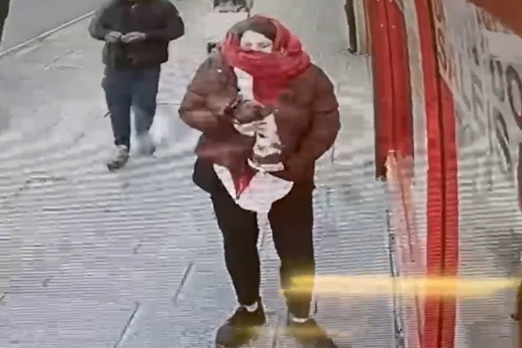 CCTV footage of Marten holding baby Victoria under her coat outside Special Connection in East Ham, London