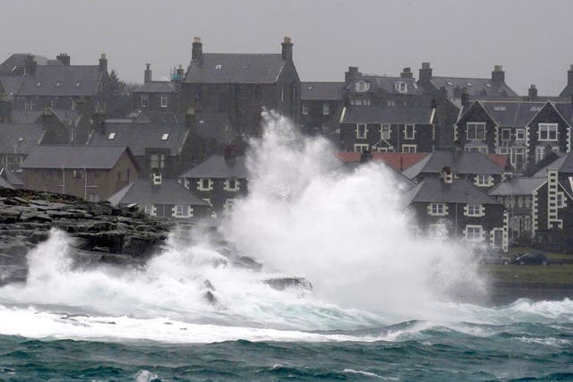 <p>Waves were pictured crashing off rocks in Lerwick, Shetland, on Wednesday</p>