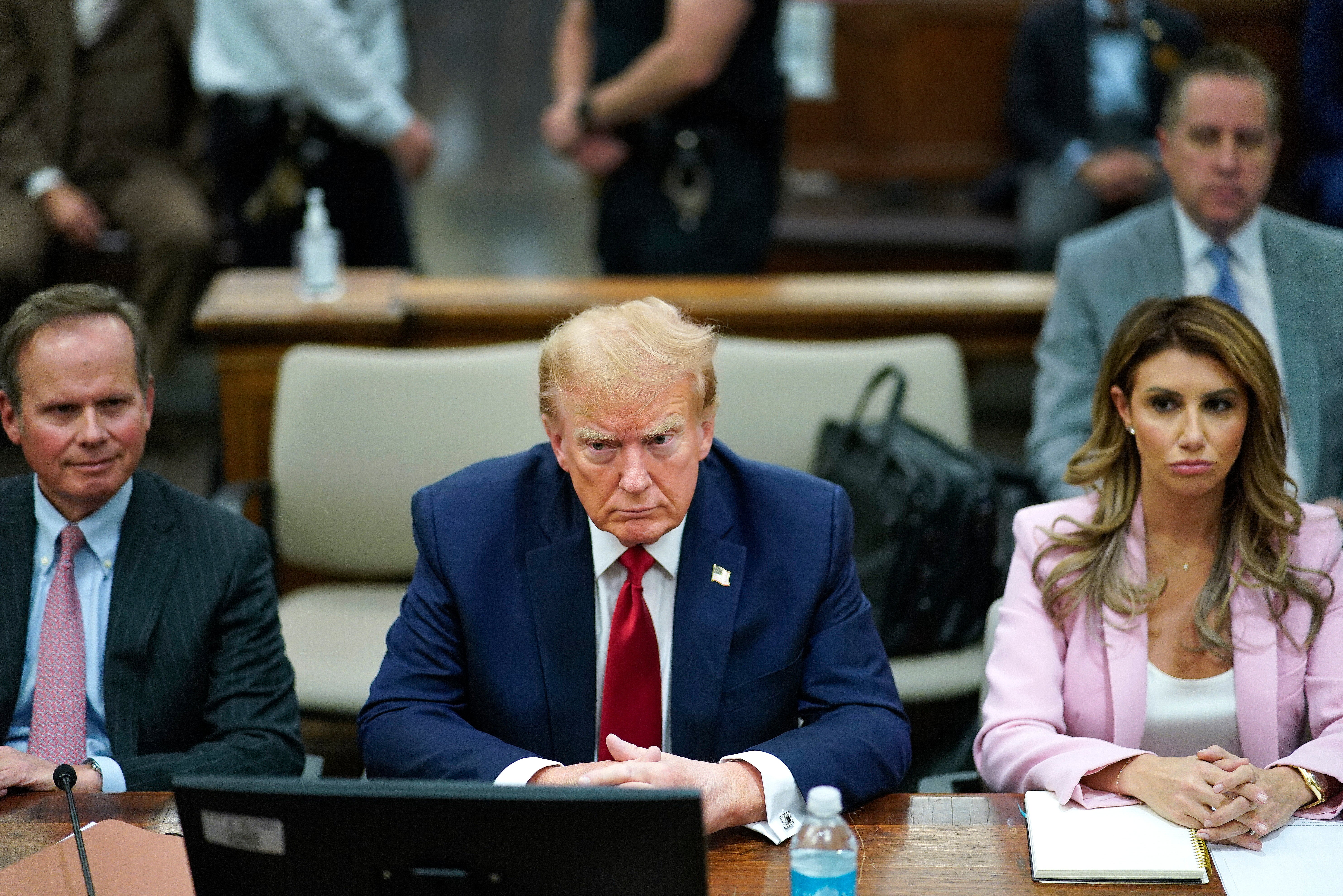 Donald Trump sits with his attorneys Chris Kise, left, and Alina Habba, right, during a civil fraud trial in New York on 7 December.