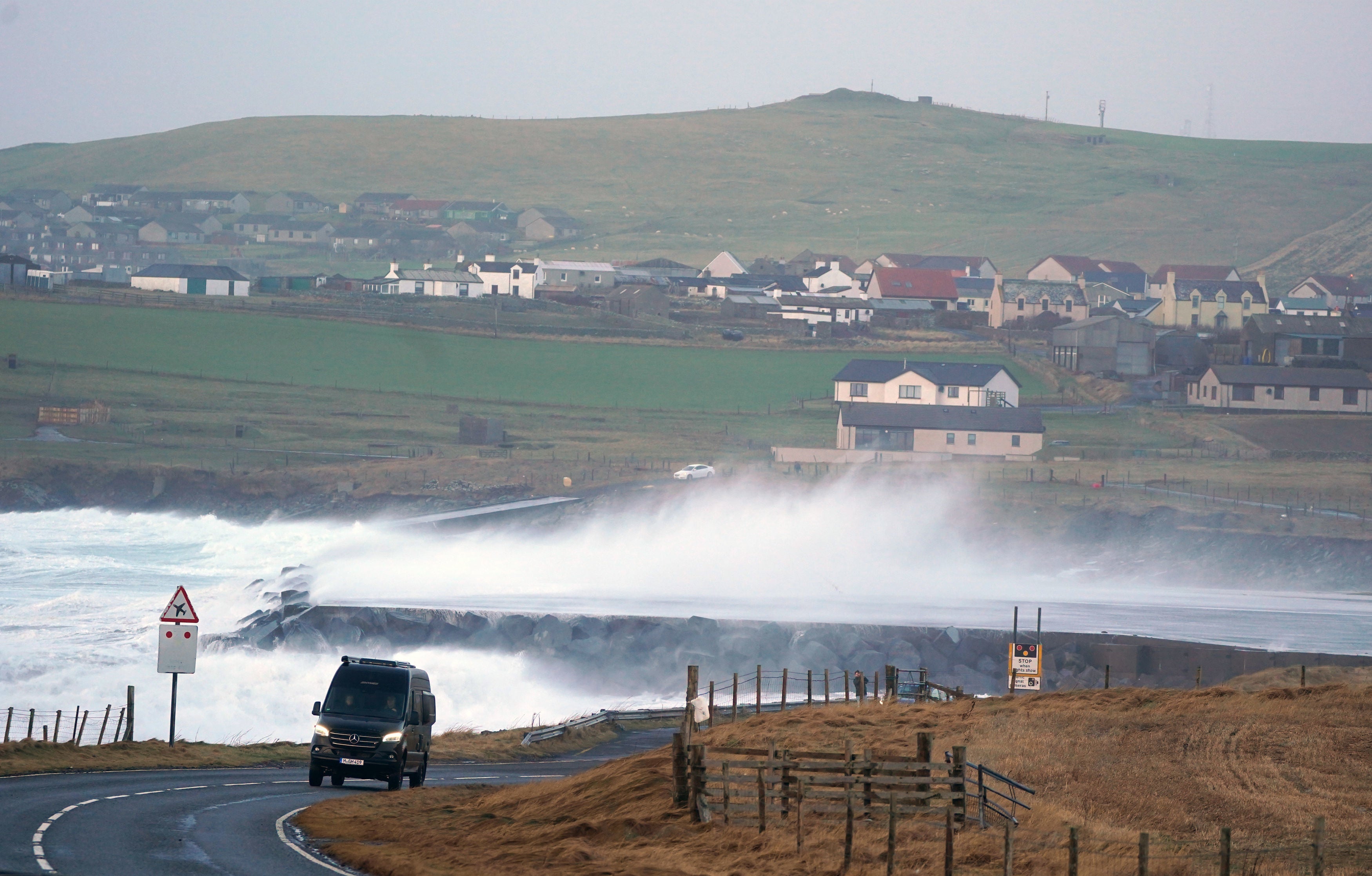 Waves crash over the end of the runway at Sumburgh Airport on Shetland