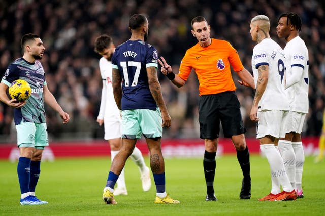 Referee David Coote speaks to Brentford and Tottenham players during a heated London derby (Zac Goodwin/PA)
