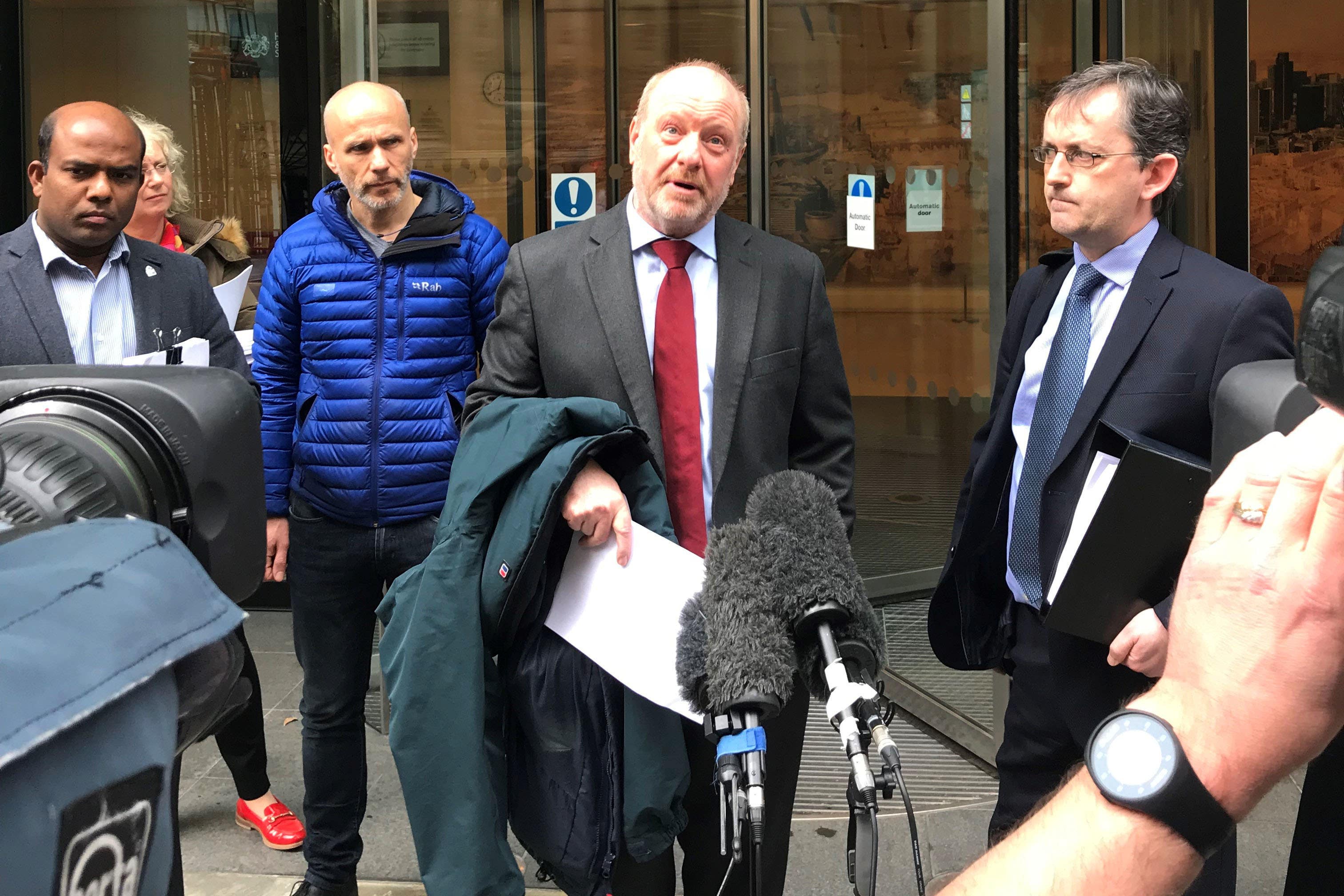 Alan Bates (centre) speaking outside the High Court in London (PA)