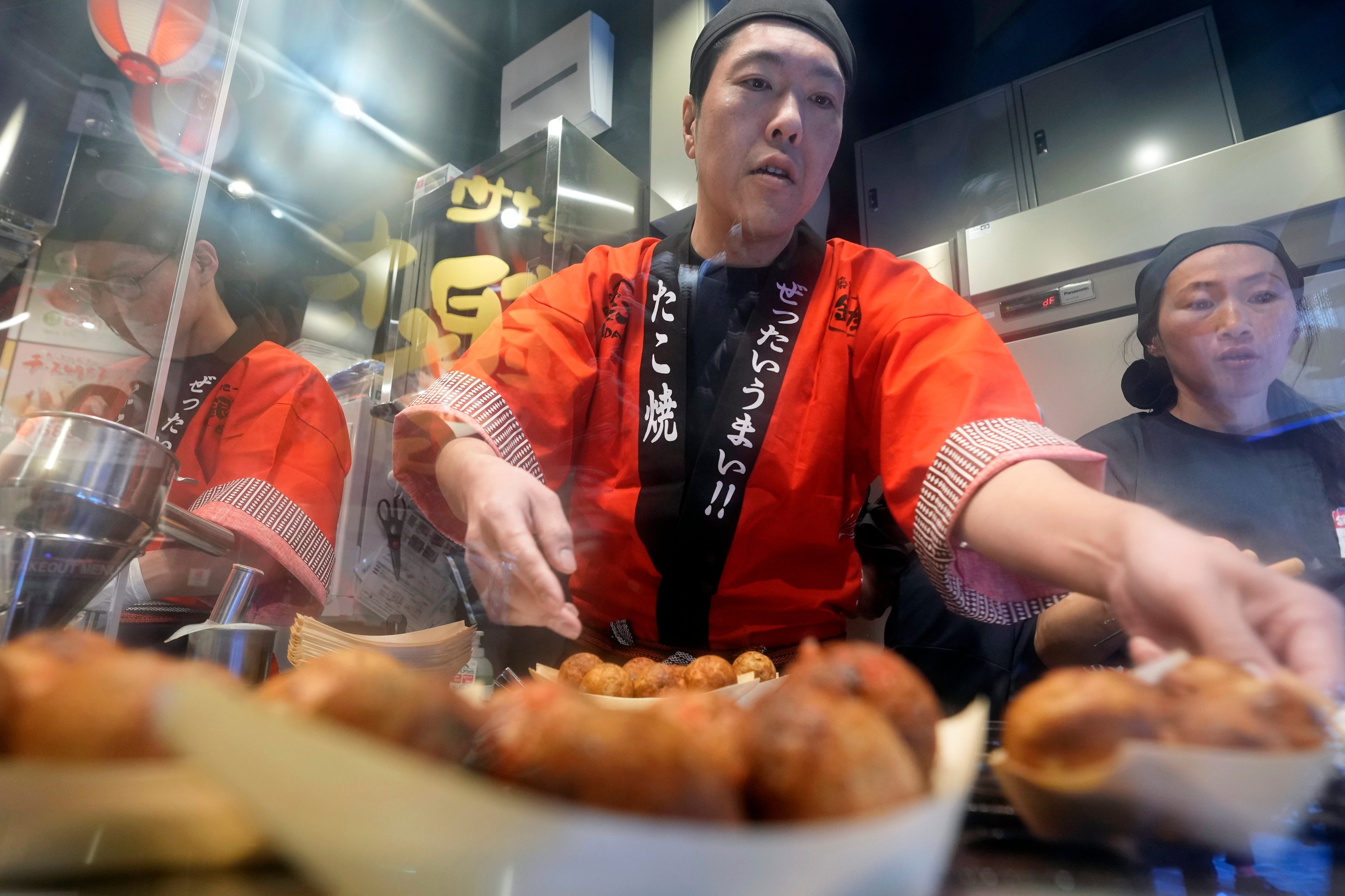 Staff prepare octopus dumplings at Toyosu Senkyaku Banrai, an Edo Period-themed hot spring complex on media preview event at Toyosu Market Monday in Tokyo