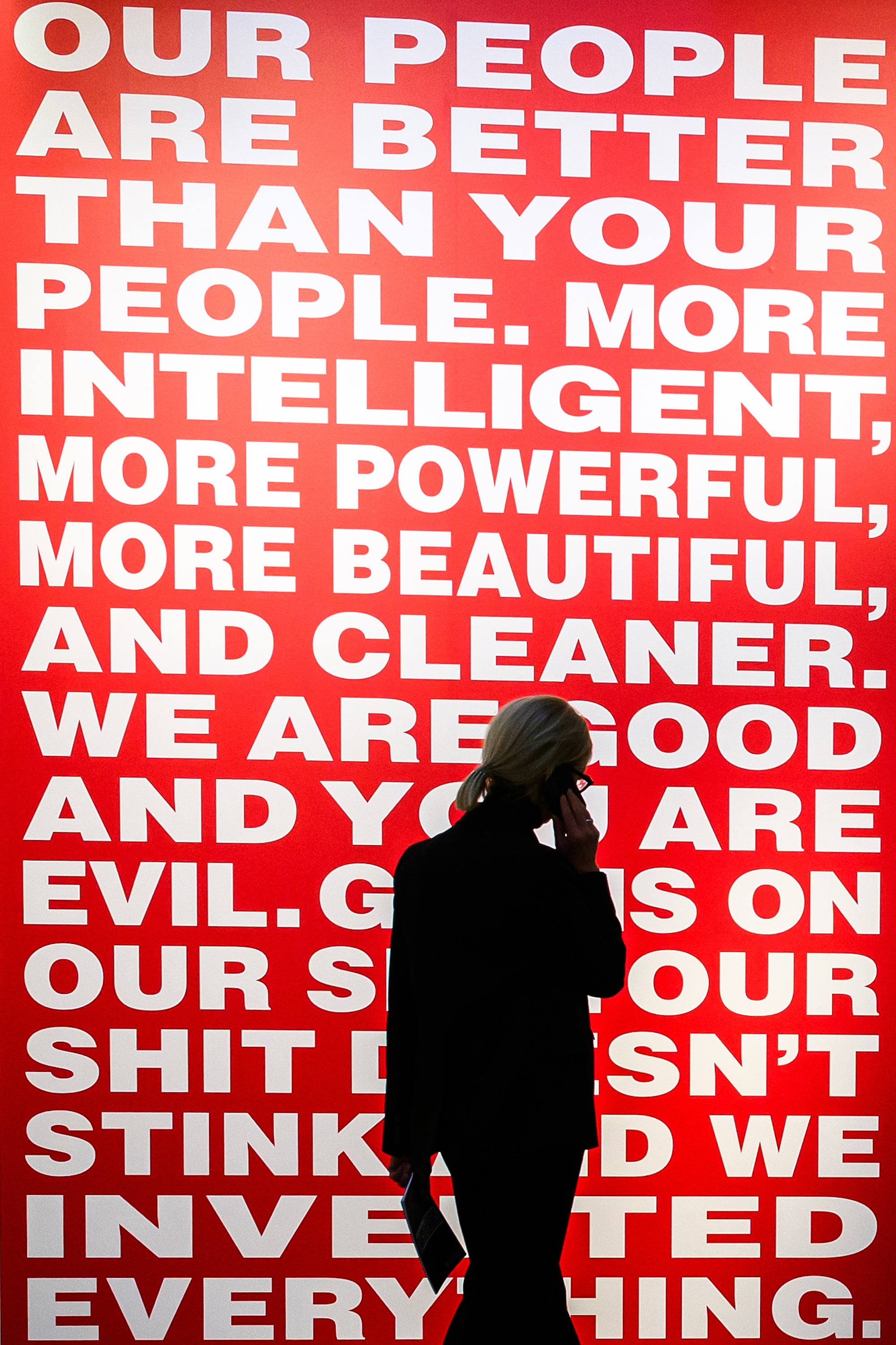 A woman walks past Kruger’s ‘Untitled (Our people are better than your people)’ at the Serpentine