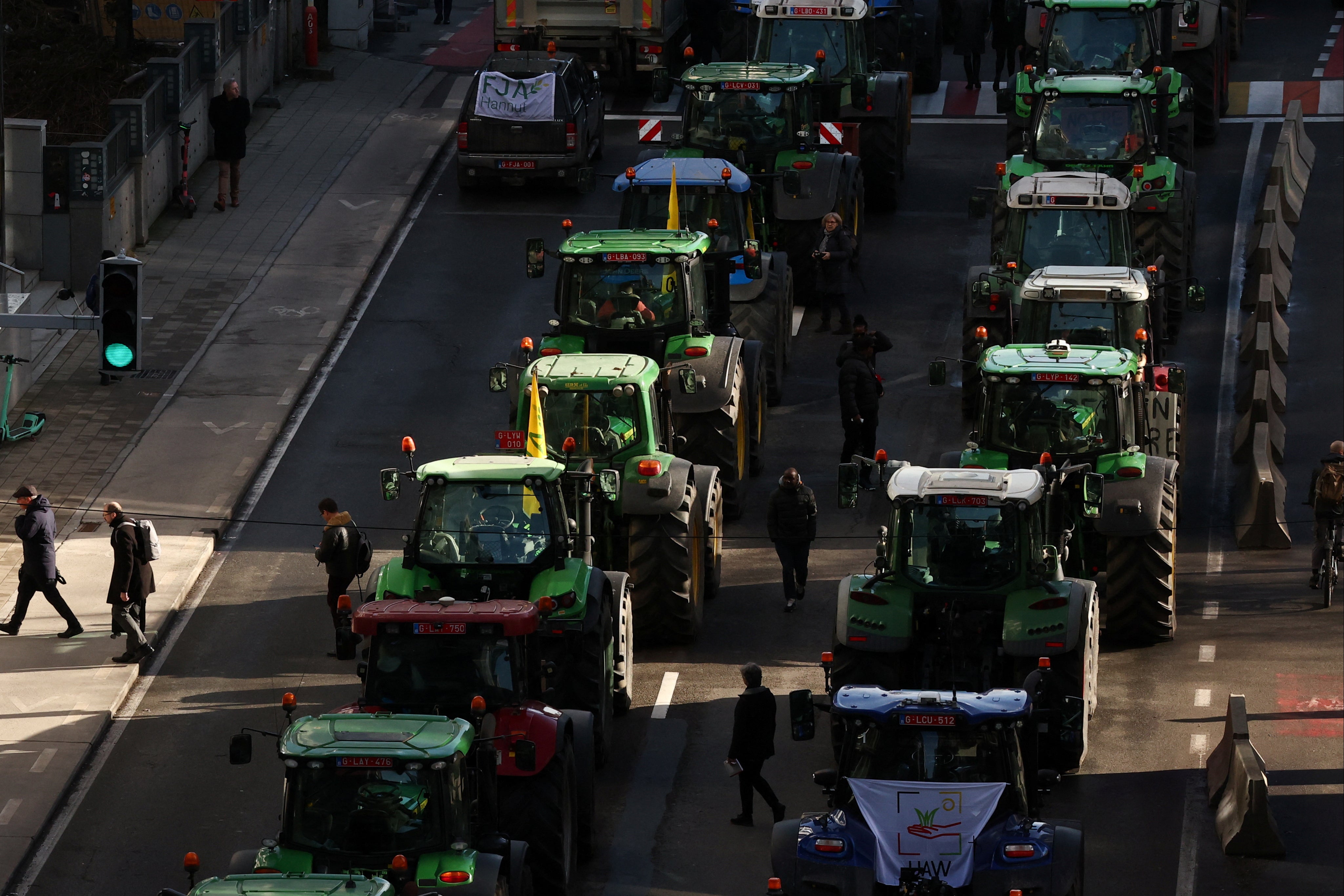 Belgian farmers block a road with tractors near the European parliament