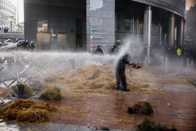 <p>Anti-riot police use water to disperse people during a protest by farmers outside the European parliament in Brussels </p>