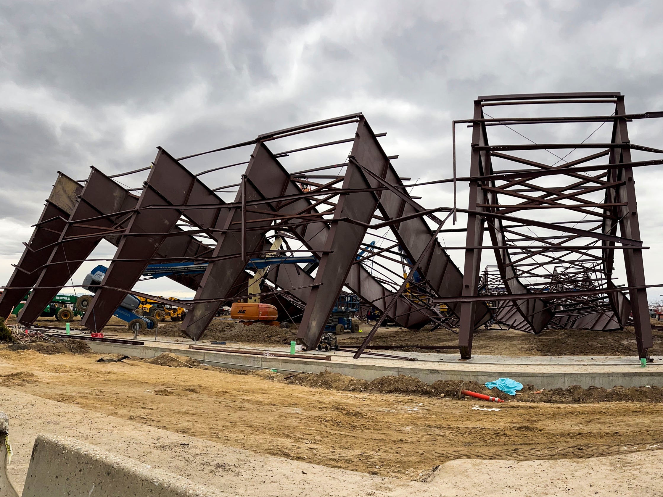 Twisted girders and debris cover the ground from a deadly structure collapse at a construction site near the Boise Airport on Thursday, Feb. 1, 2024 in Boise, Idaho