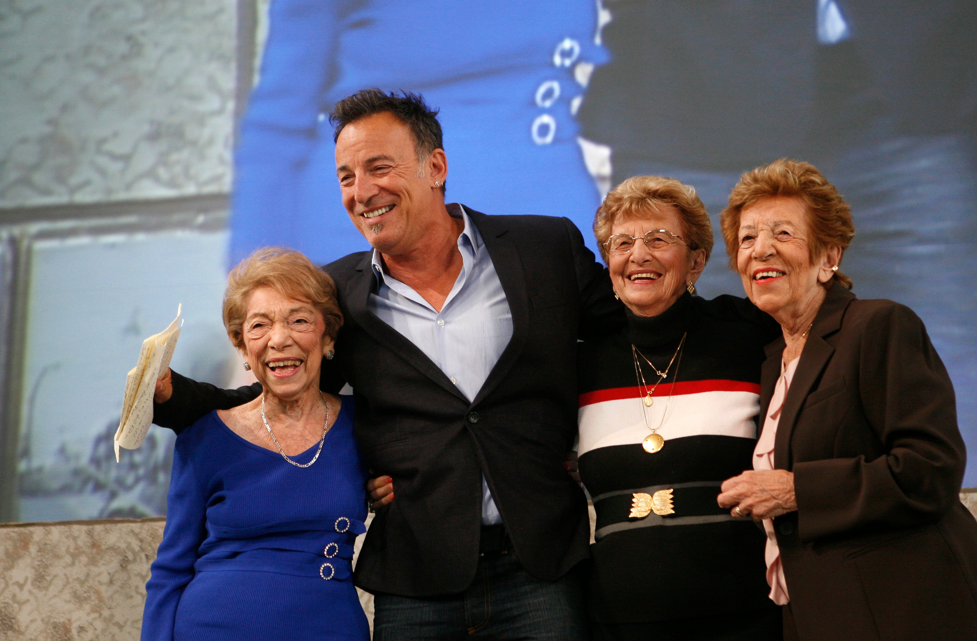 Bruce with his mum Adele (left) and aunts during his Ellis Island speech in 2010