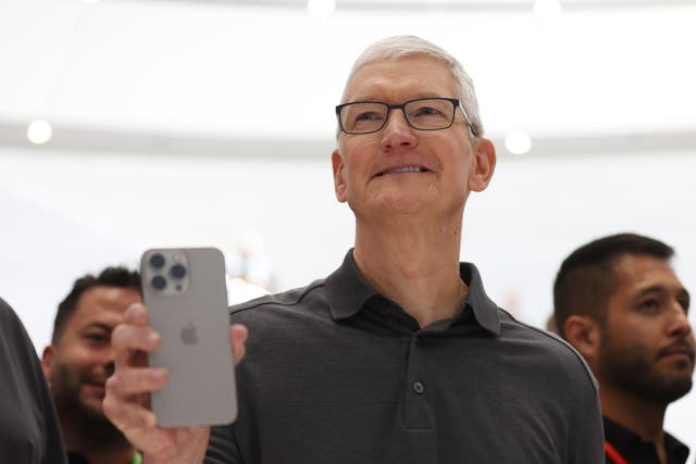 <p>Apple CEO Tim Cook holds up a new iPhone 15 Pro during an Apple event on September 12, 2023 in Cupertino, California</p>