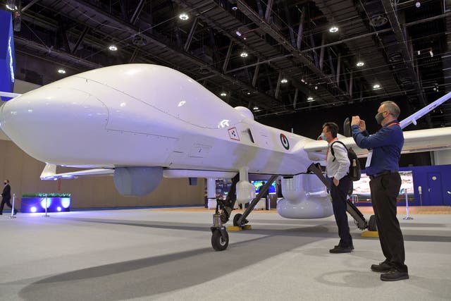 <p>Visitors view a MQ-9B Sea Guardian Drone by General Atomics Auronautical on display at the UMEX Exhibition showcasing drones, robotics, and unmanned sytems at the Abu Dhabi National Exhibition Centre</p>