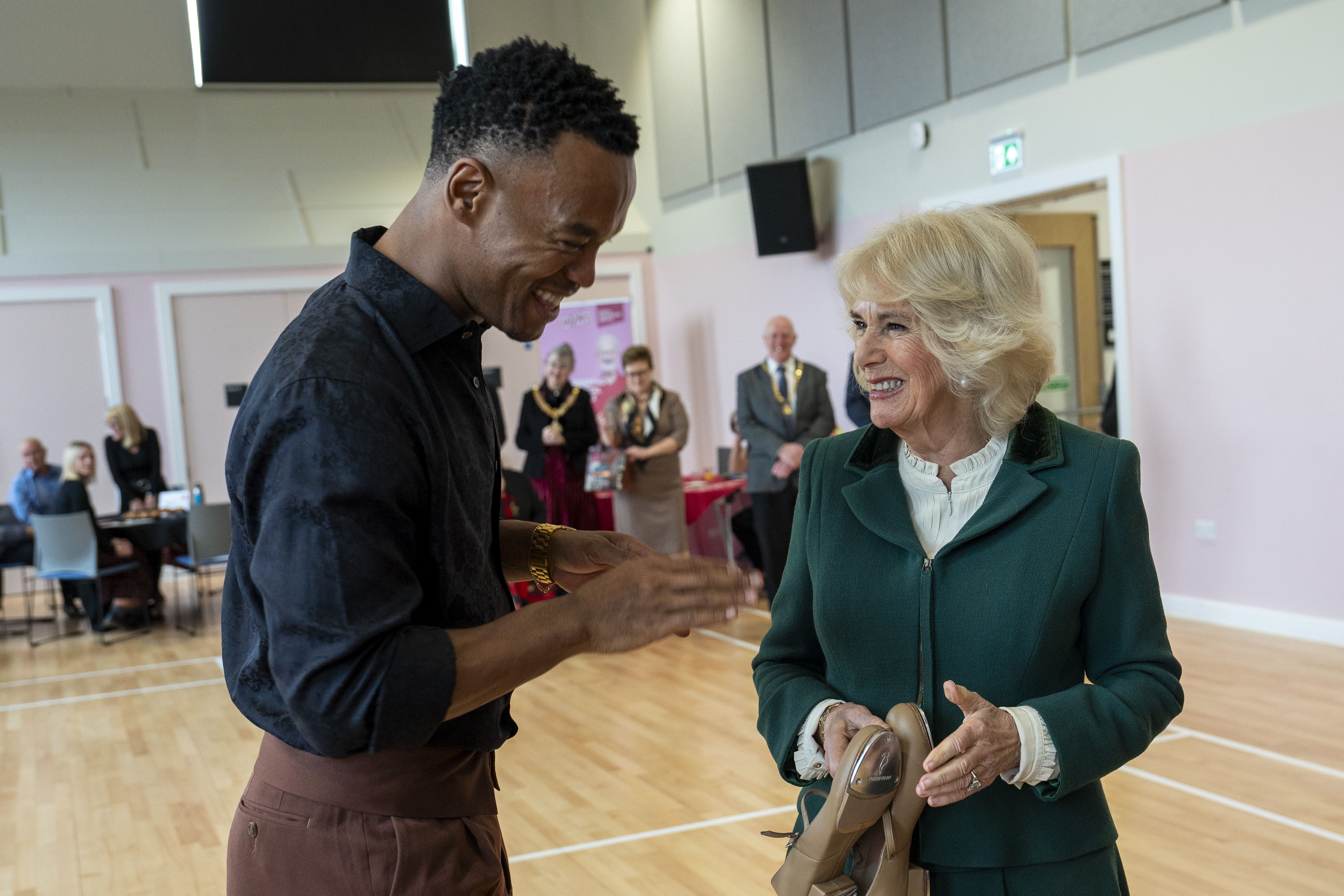 Queen Camilla is presented with a pair of tap shoes by dancer Johannes Radebe (Arthur Edwards/The Sun/PA)
