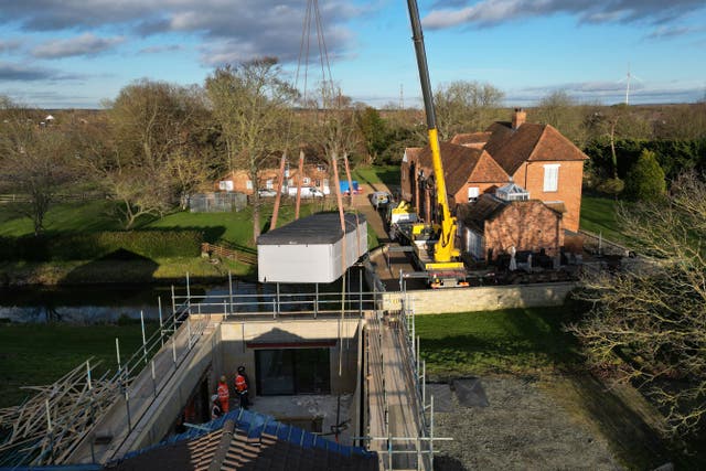 A spa pool is removed from an unauthorised spa pool block at the home of Hannah Ingram-Moore, the daughter of the late Captain Sir Tom Moore (Joe Giddens/PA)