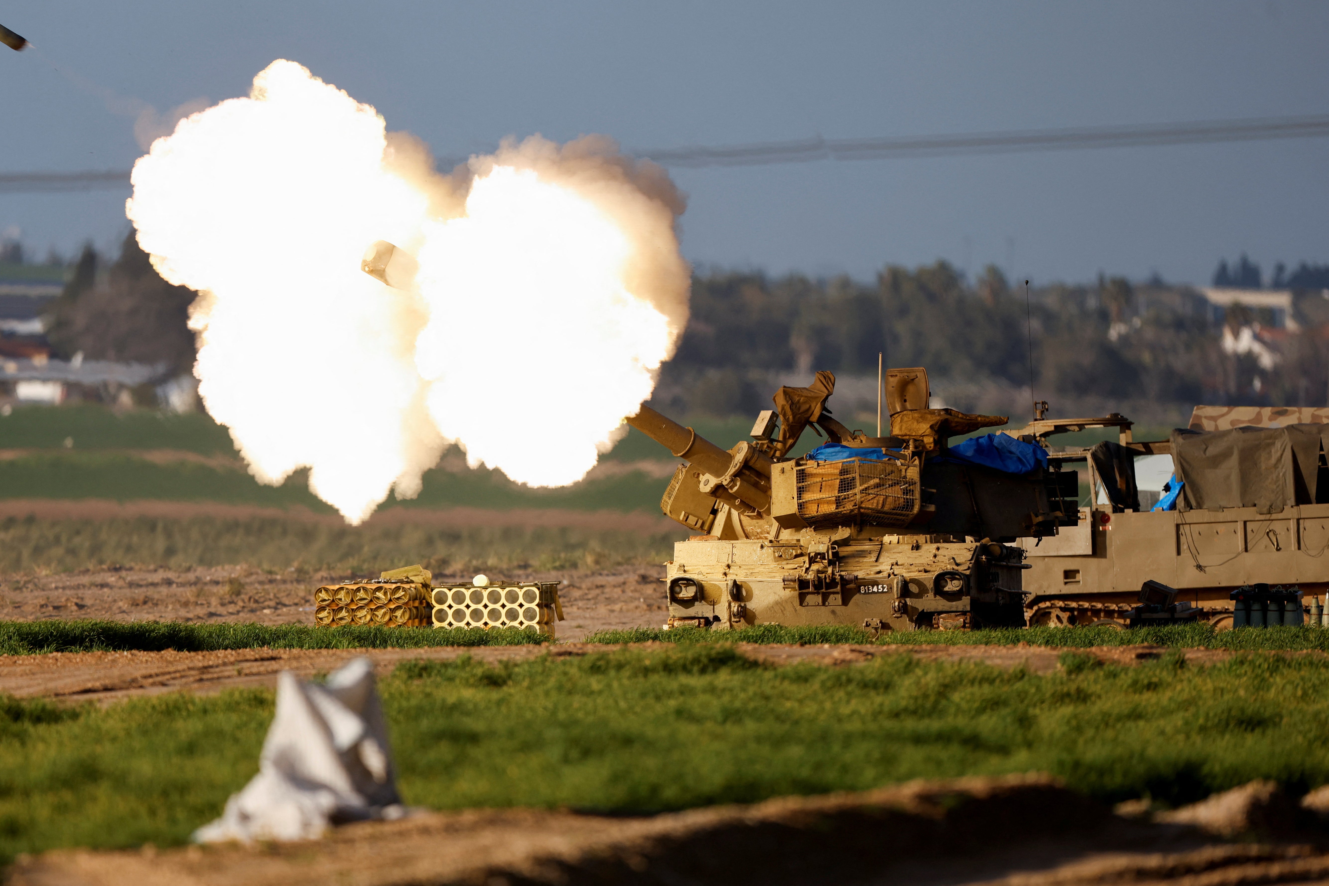An Israeli mobile artillery unit fires towards Gaza