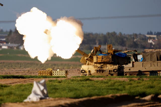 <p>An Israeli mobile artillery unit fires towards Gaza</p>