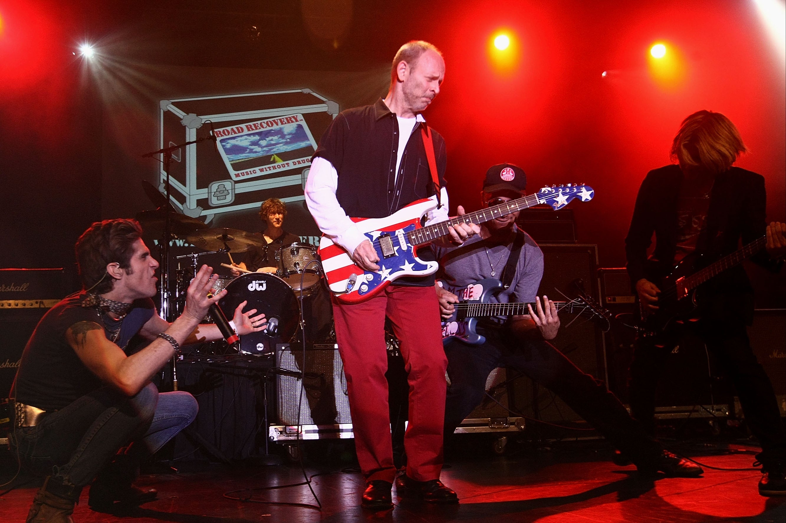 Wayne Kramer onstage in New York in 2009, surrounded by Perry Farrell, Tom Morello and Carl Restivo