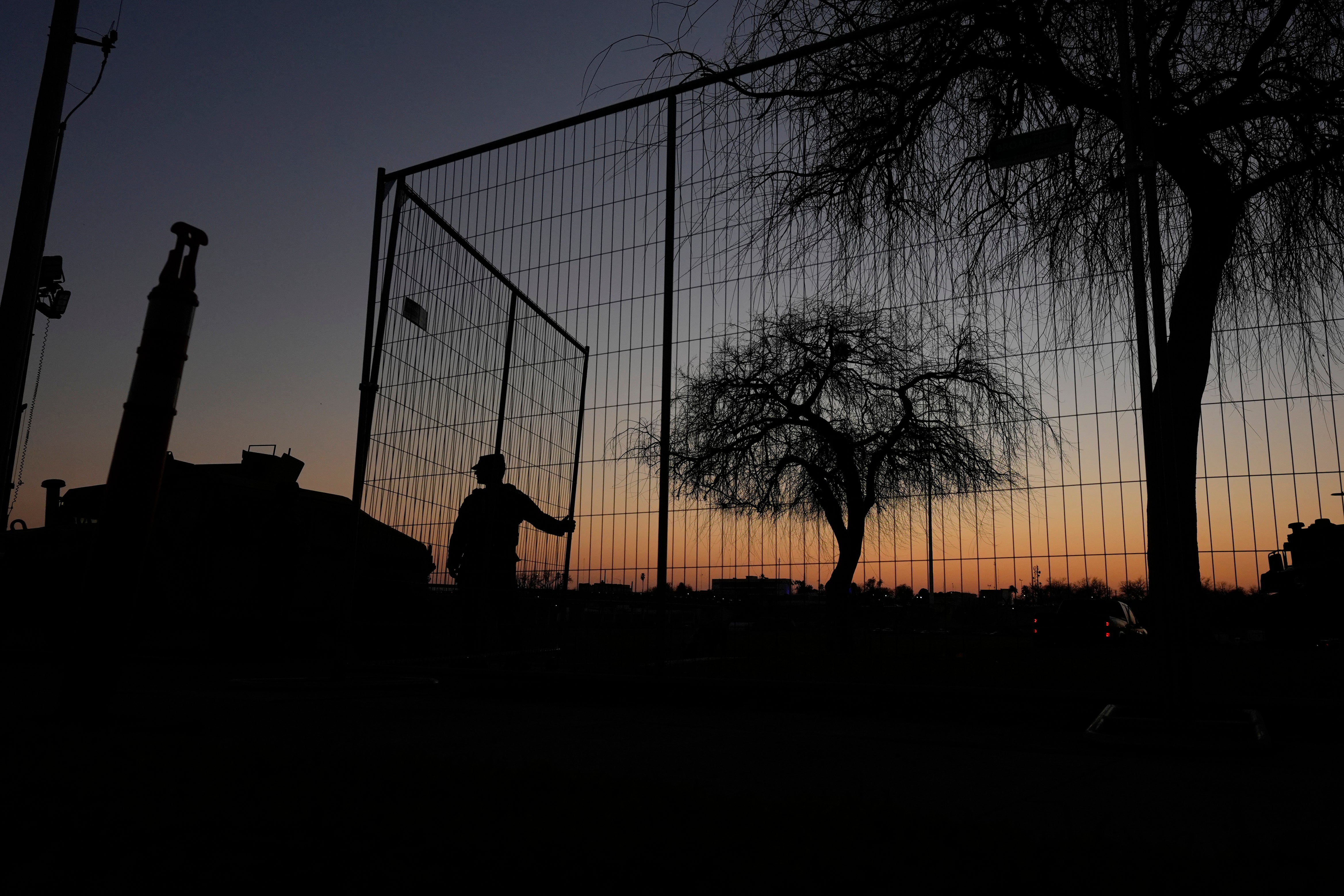 A guardsman opens a gate at Shelby Park, which troops from the Texas National Guard seized and began turning away federal immigration authorities, Thursday, Feb. 1, 2024, in Eagle Pass, Texas