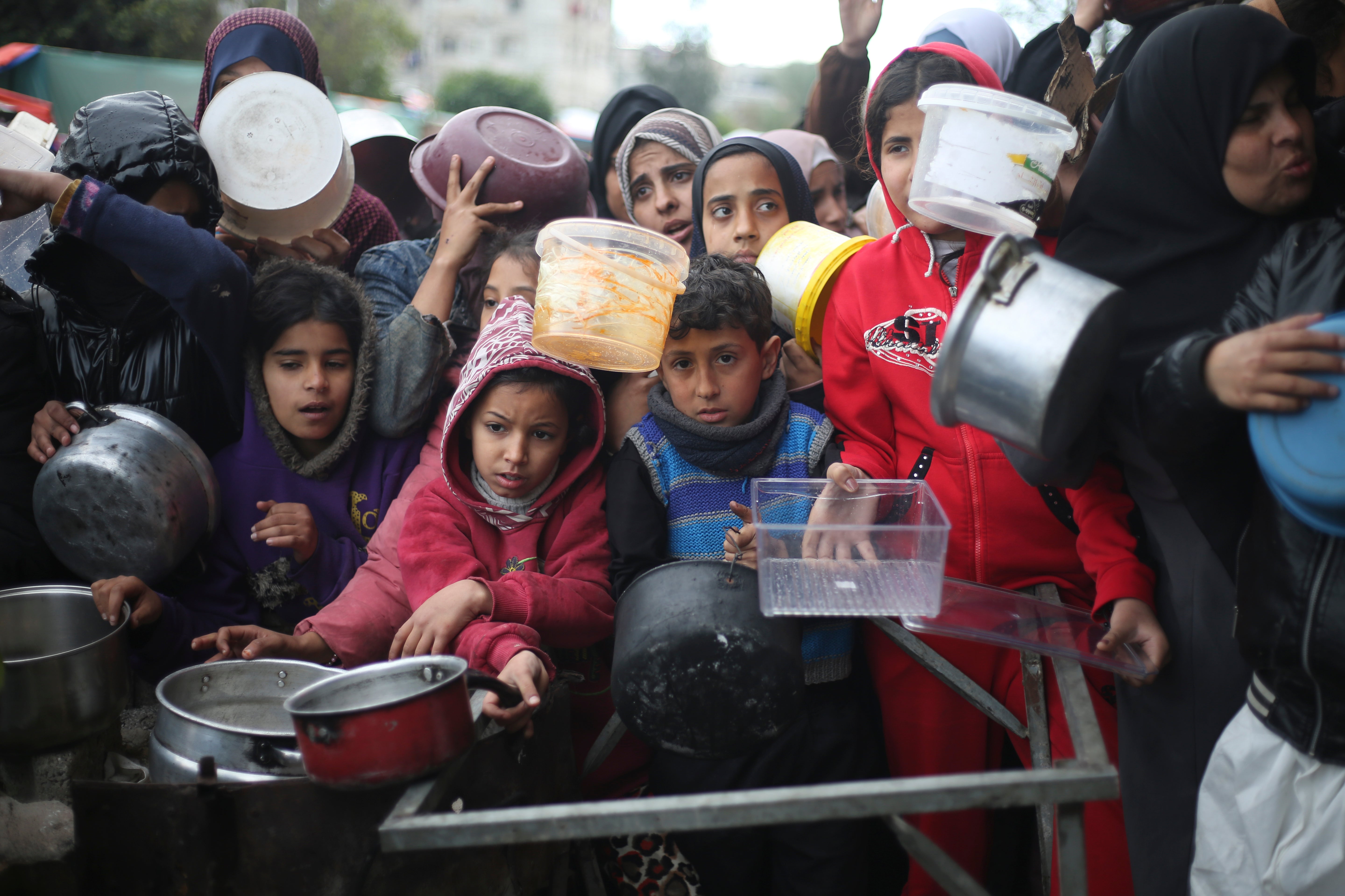 Palestinians line up for free food distribution during the ongoing Israeli air and ground offensive in Khan Younis, Gaza Strip, Friday, Feb. 2, 2024.