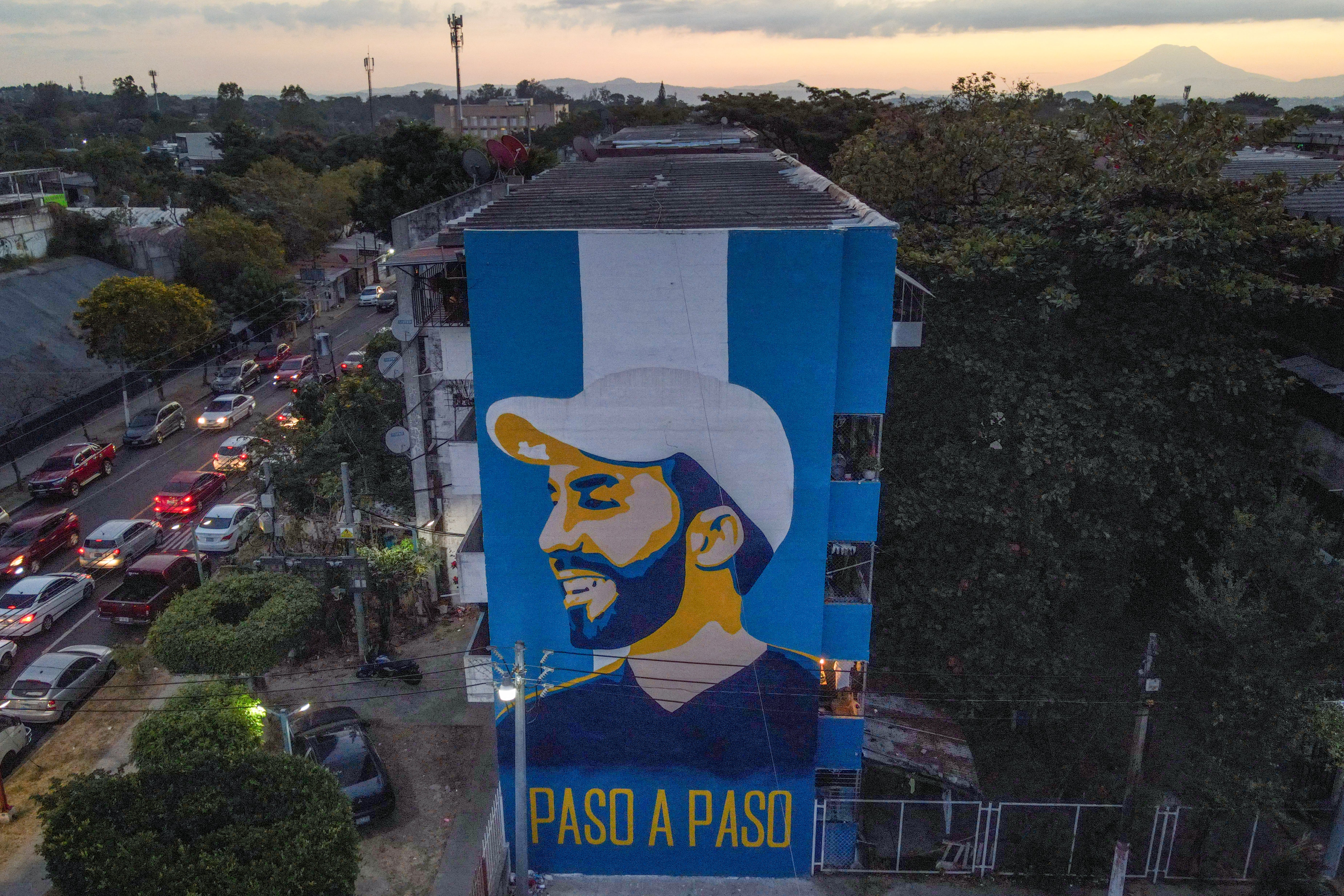 A mural at the Zacamil apartment complex in Mejicanos depicting Salvadoran president Nayib Bukele. It reads ‘Step by Step'