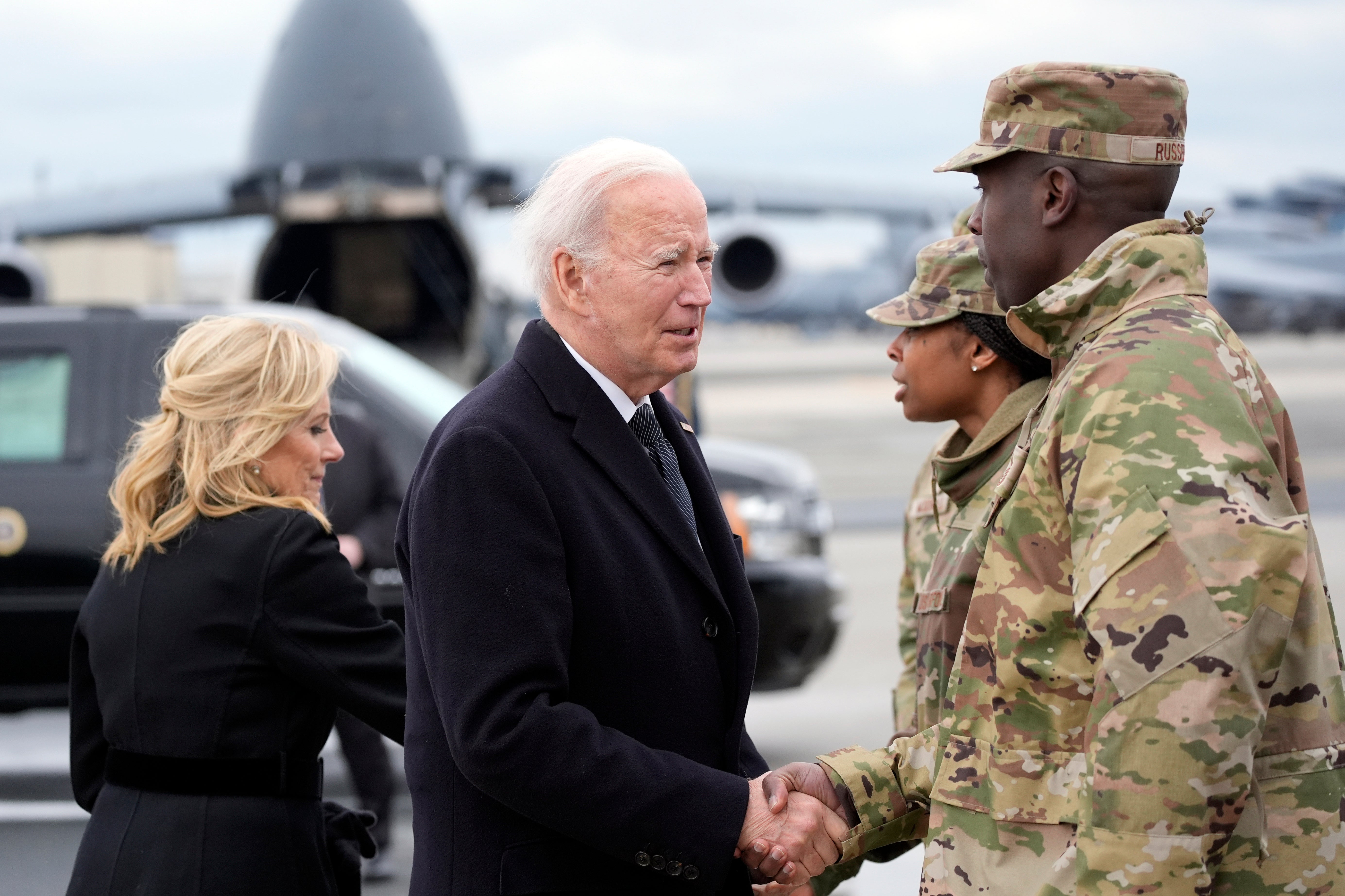 Joe Biden and first lady Jill Biden greet service members before boarding Air Force One
