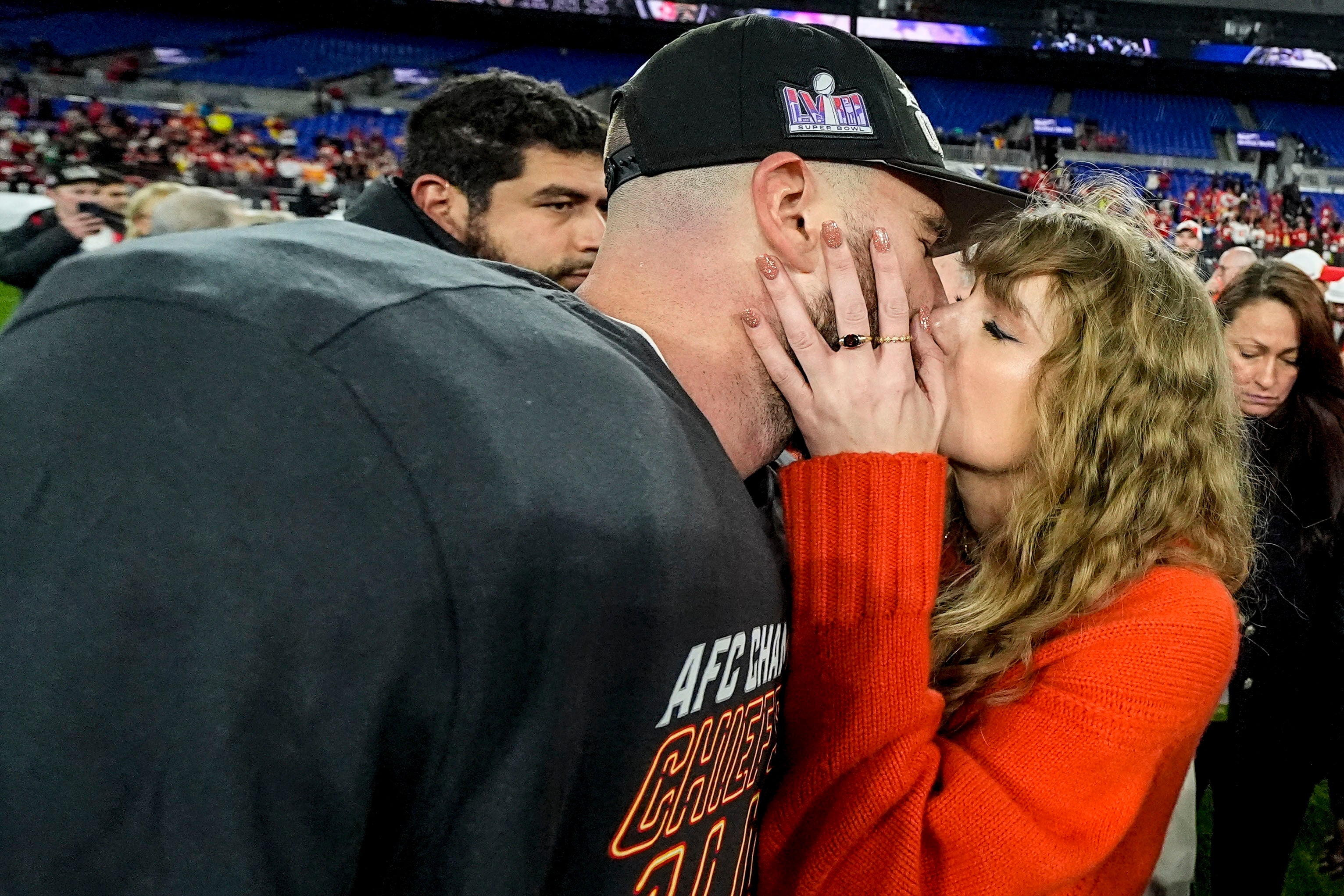 Taylor Swift kisses Travis Kelce after the Chiefs won the game that advanced them to the 2024 Super Bowl