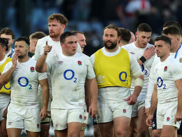 <p>England players show relief after victory over Italy in Rome</p>