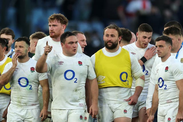 <p>England players show relief after victory over Italy in Rome</p>