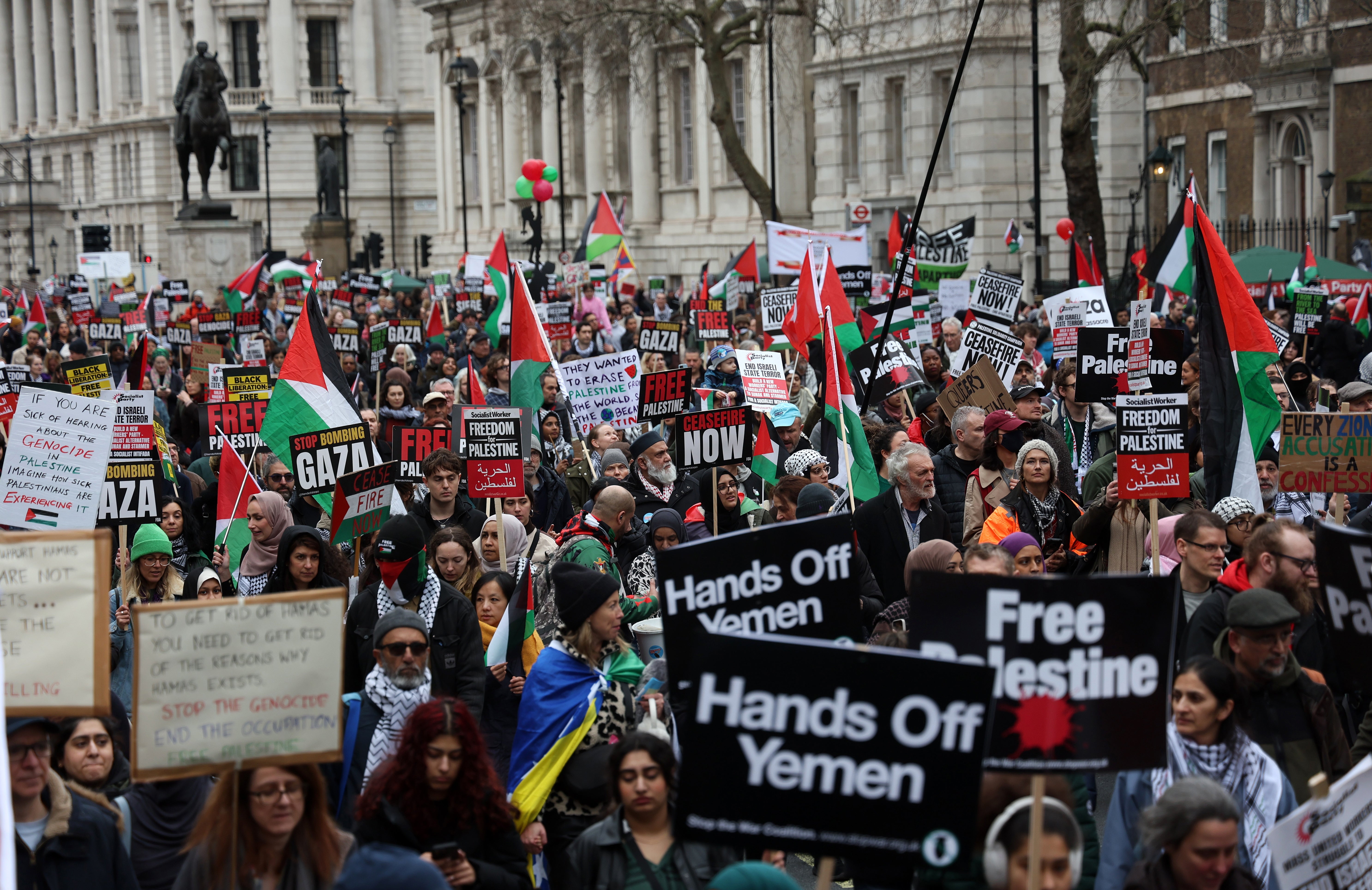 Pro-Palestinian protesters carry placards during a 'National March for Palestine' demonstration in central London