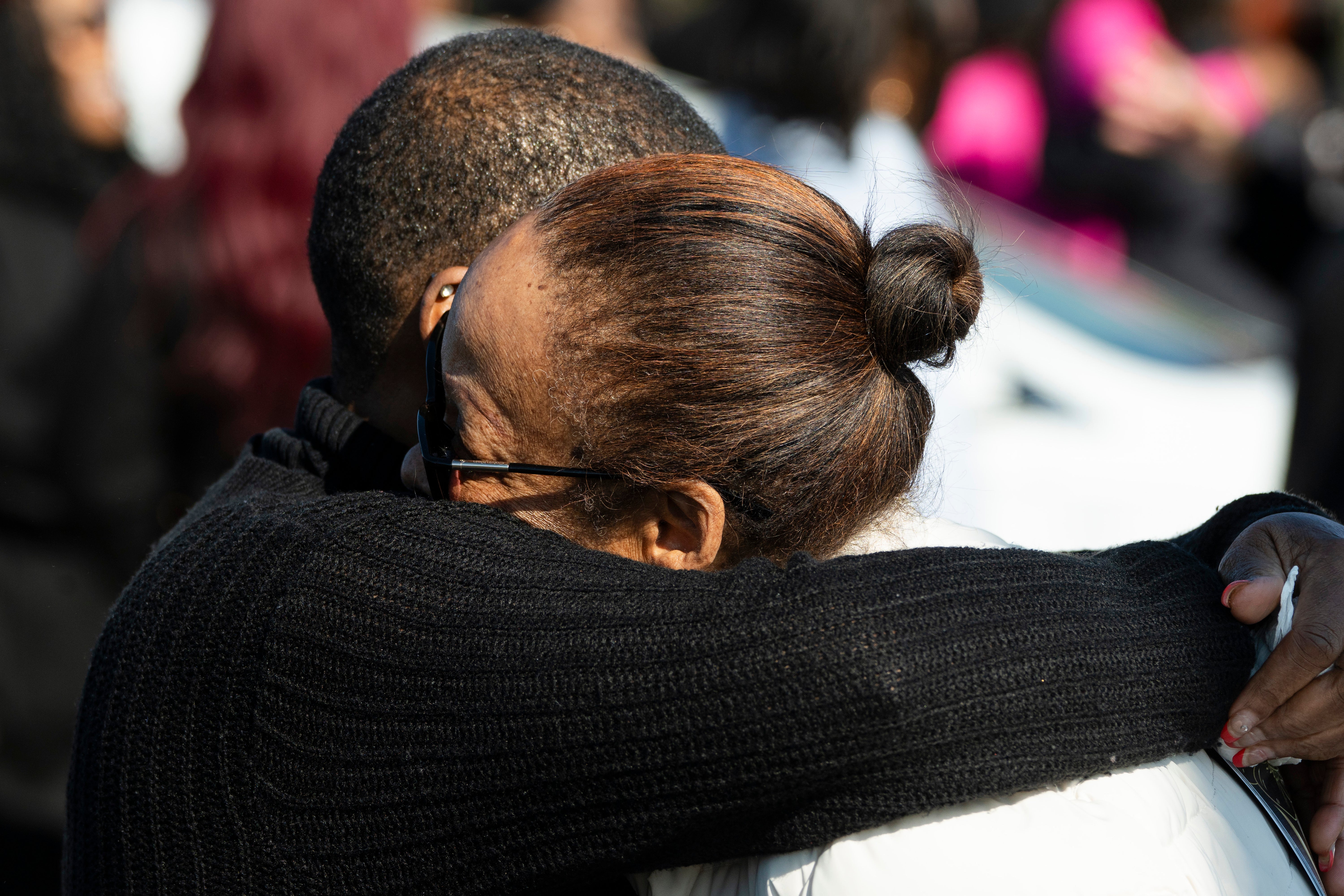 Mourners hug outside Victory City Church in Joliet, Ill. after the funeral for Christine and William Esters, Tameaka, Joshua, Alexandria, Alonnah and Angel Nance.Romeo Nance killed all seven of his relatives and another victim