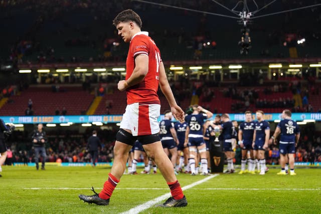 Wales’ Teddy Williams walks past as Scotland players celebrate with the Doddie Weir Cup (David Davies/PA)