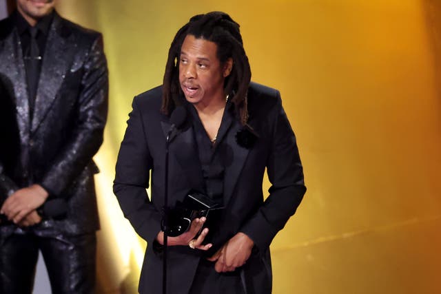 <p>Jay-Z accepting the Global Impact Award onstage during 2024 Grammy Awards</p>