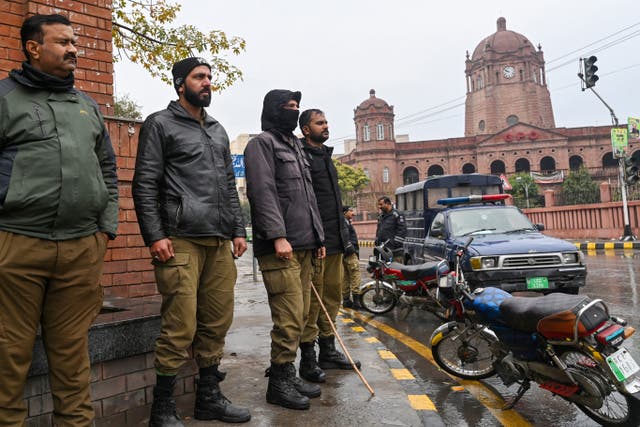 <p>Policemen stand guard along a street ahead of Pakistan’s national elections 2024 in Lahore</p>