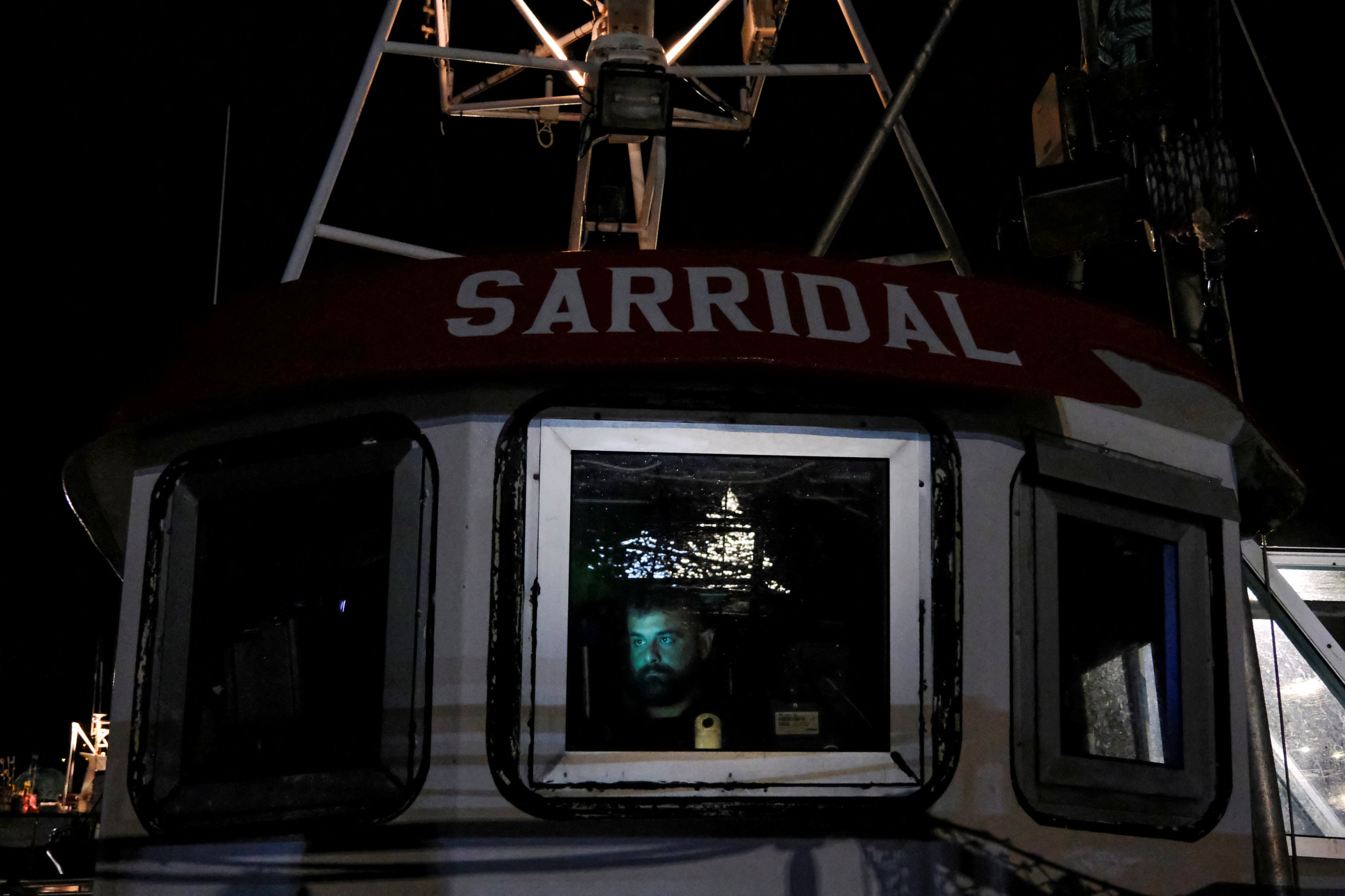 Captain Francisco Gonzalez looks at a map inside the Sarridal ship before a fishing outing to the Atlantic Ocean, at Cedeira’s port, Galicia, Spain