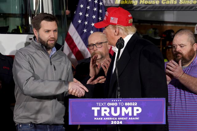 <p>JD Vance shakes hands with Donald Trump in East Palestine, Ohio in 2023</p>