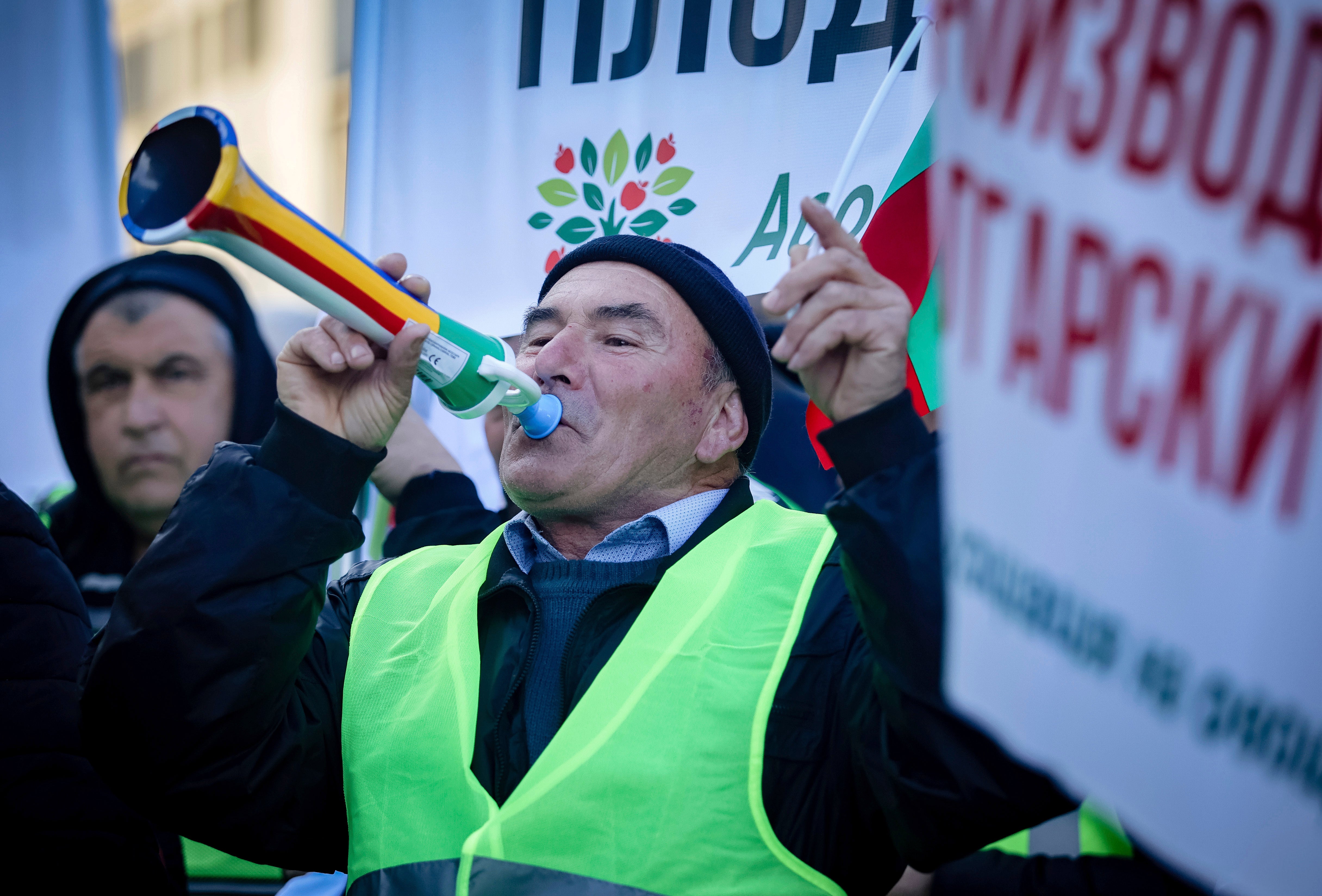 A protester blows a horn during farmers protest in front of the Agriculture Ministry in Sofia