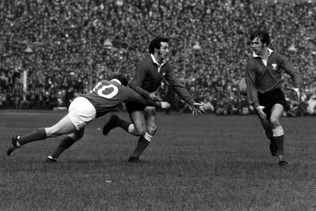 Sir Gareth Edwards (centre) and Barry John (right) in action for Wales (PA)