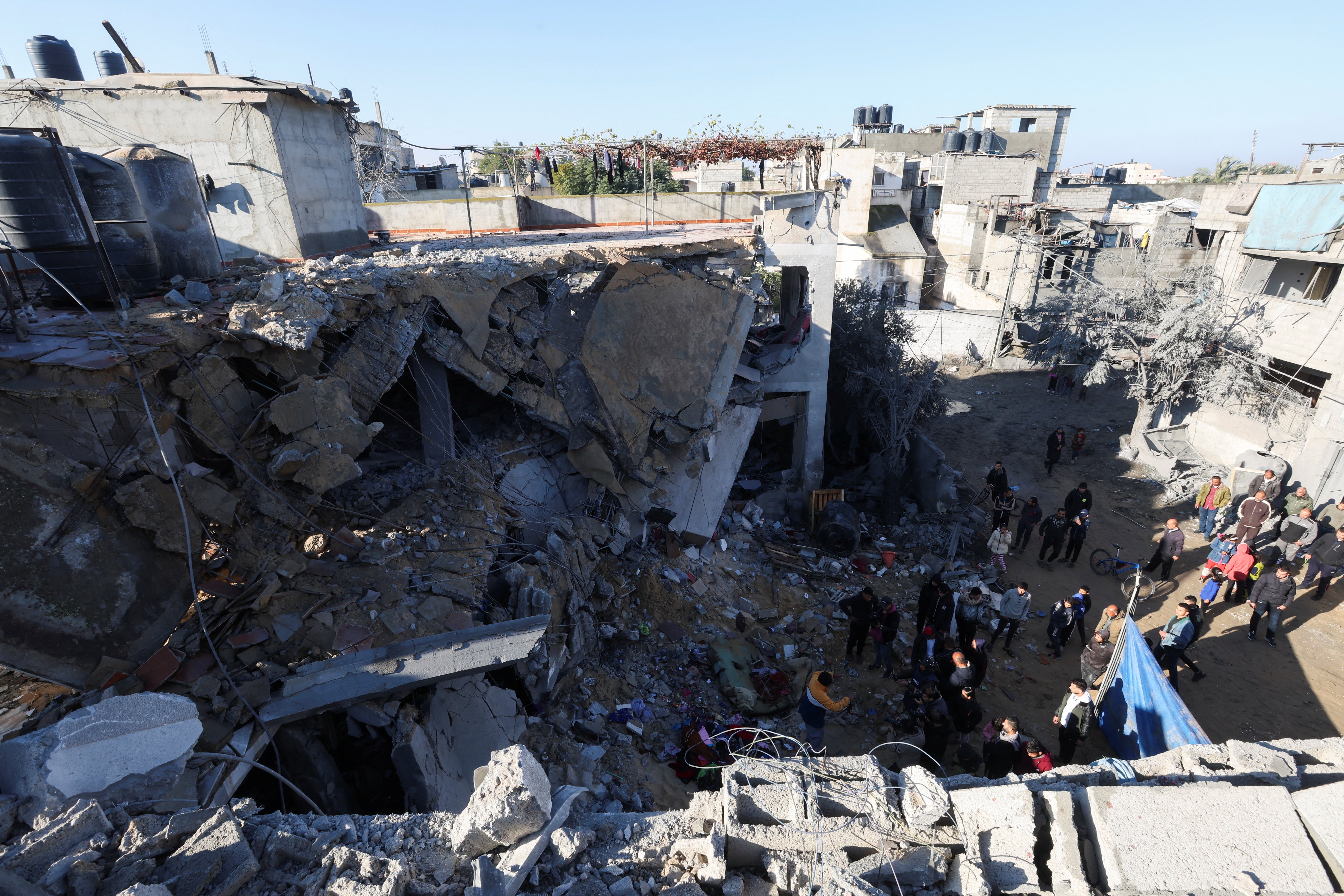 Palestinians inspect the site of an Israeli strike in Rafah, southern Gaza