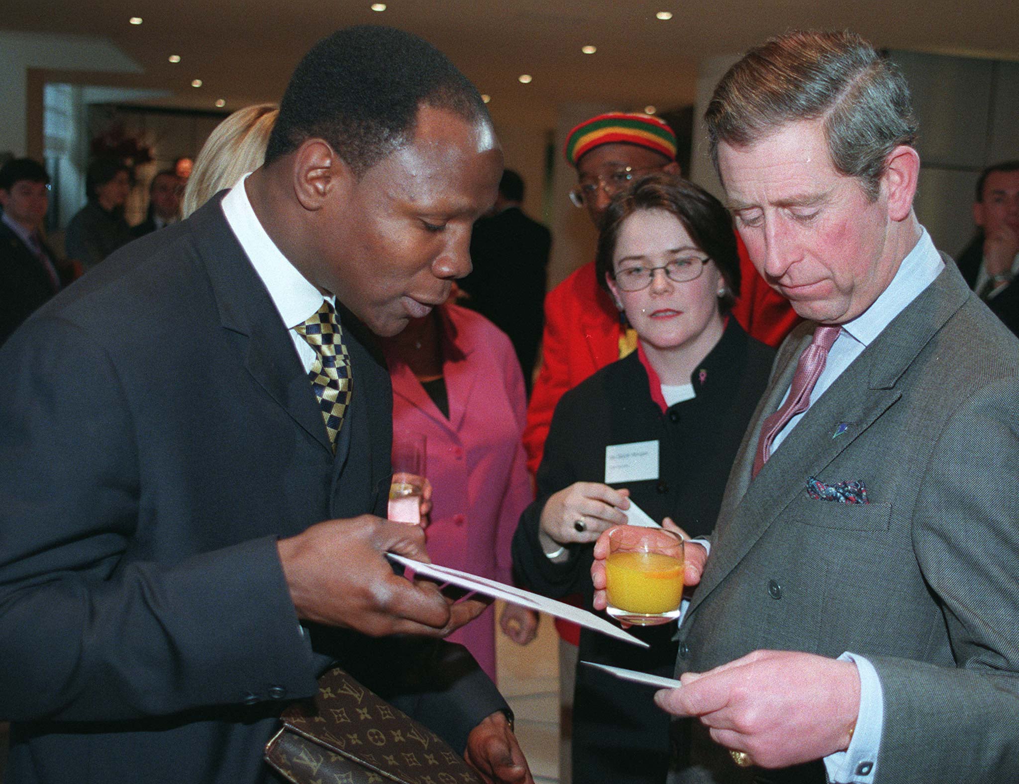 Charles enjoying an orange juice as he met boxer Chris Eubank at a Breakthrough for Breast Cancer reception in 1998
